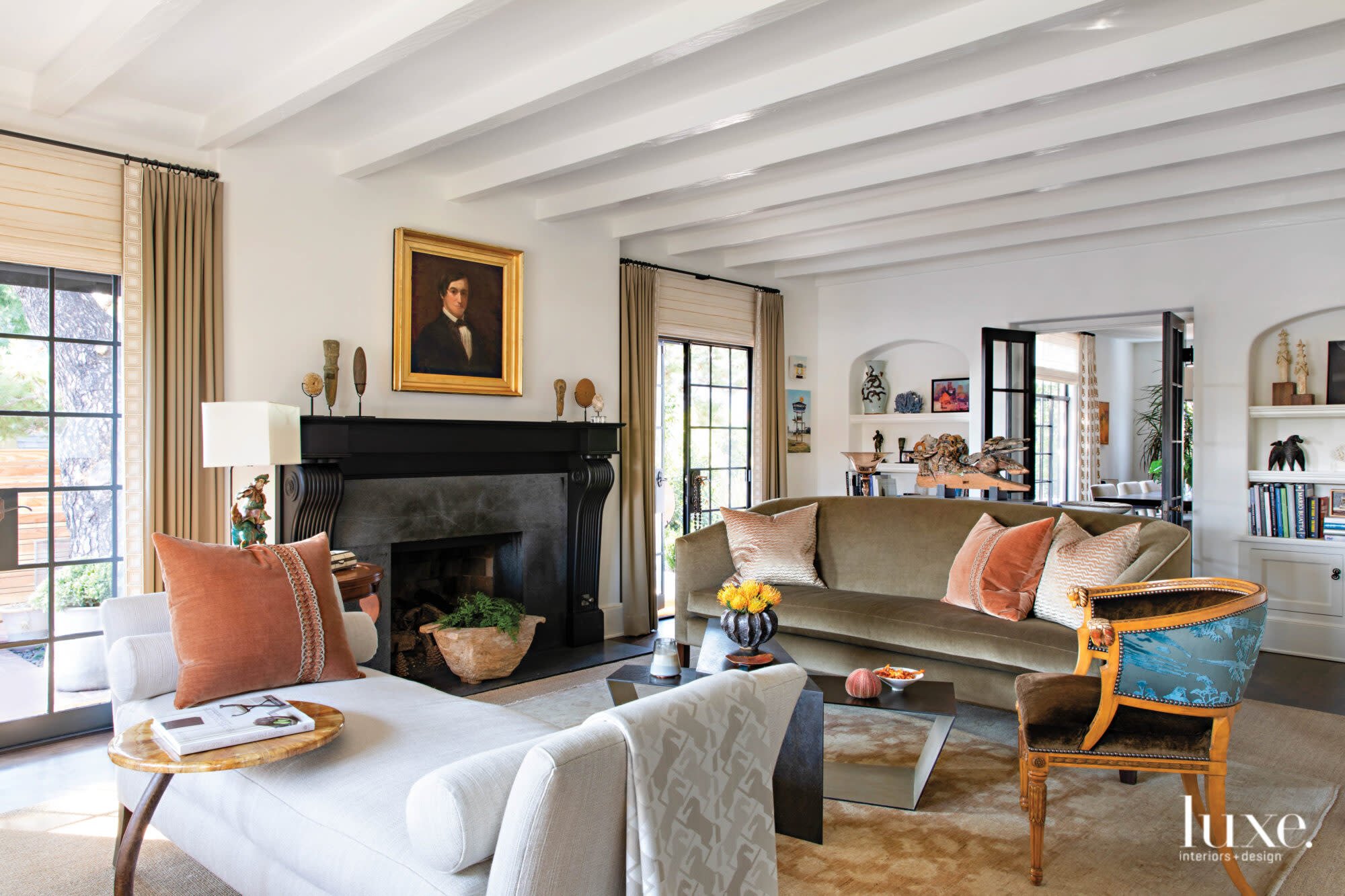 Living room with beige couch and portrait over mantel