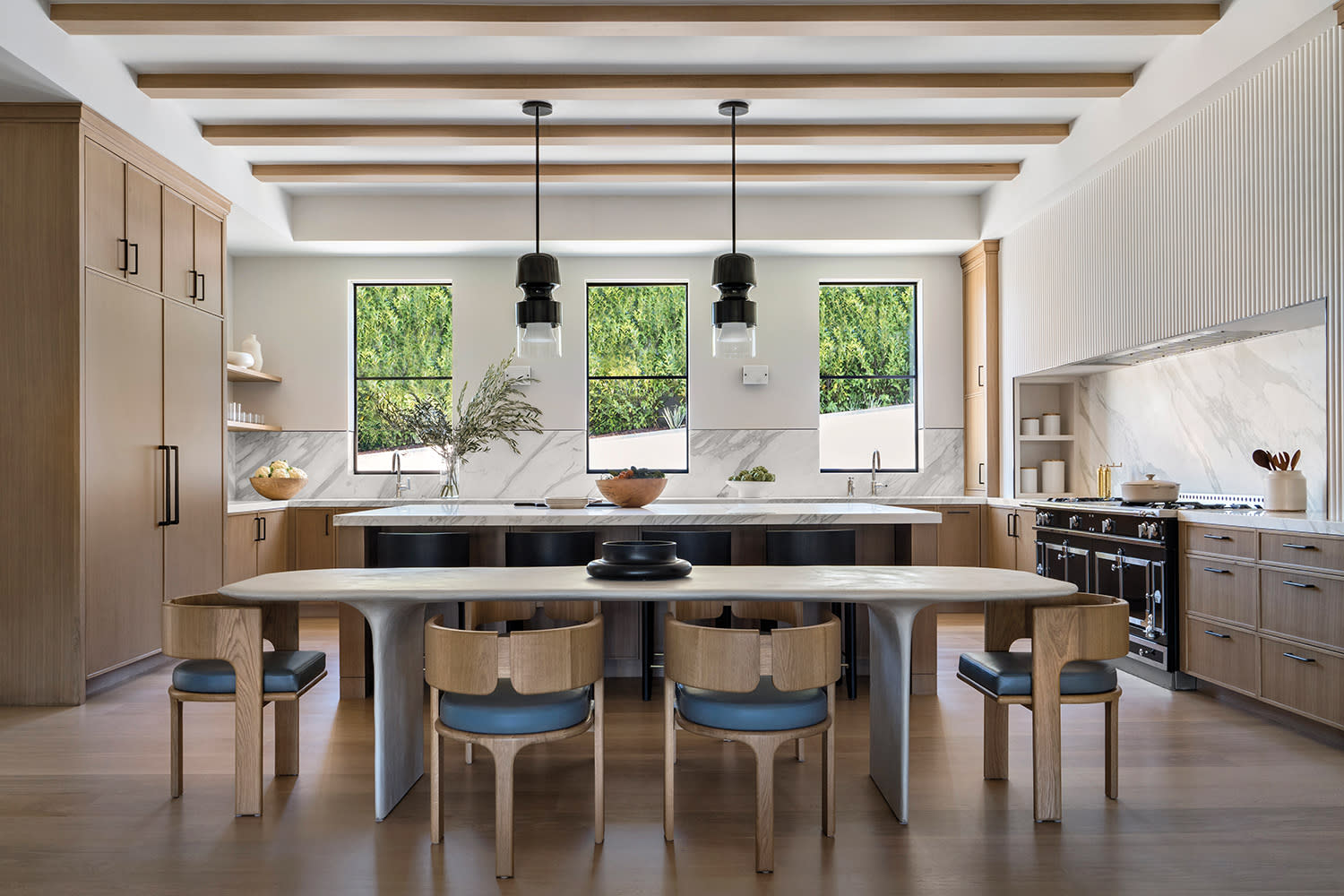 open concept kitchen with a large island and exposed beams