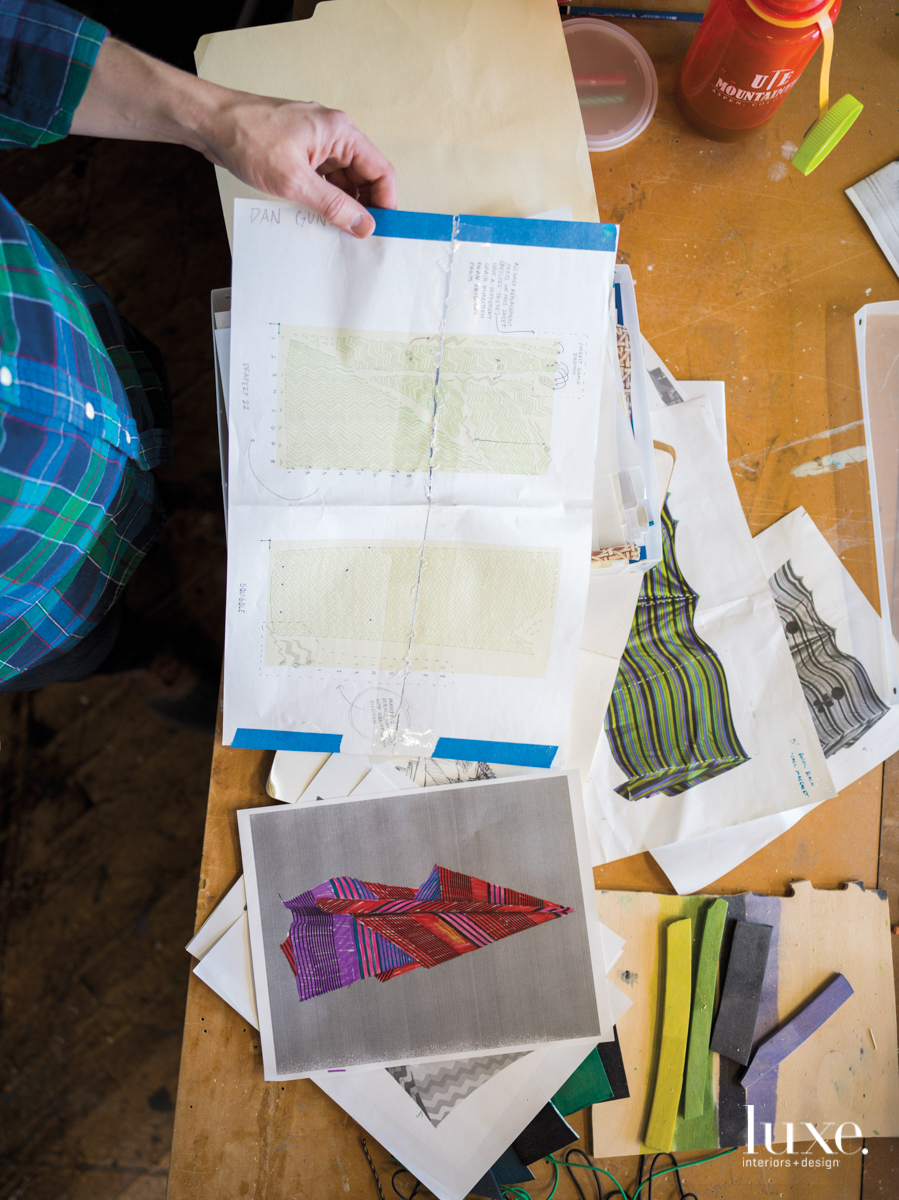Gunn holding sketches.