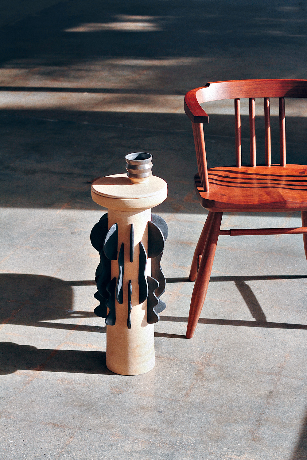 Ceramic mug sits on a Utility Ceramic side table.