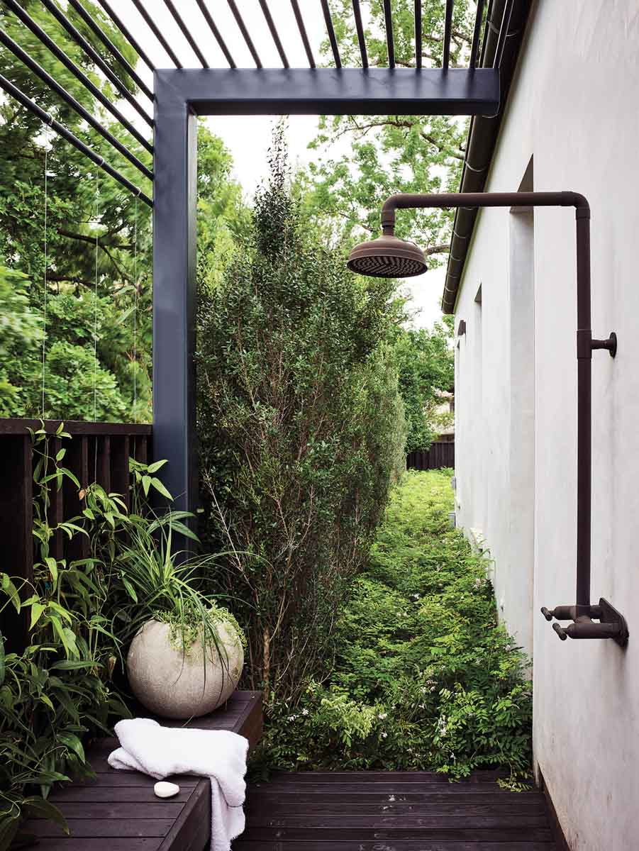 Outdoor shower surrounded by plants