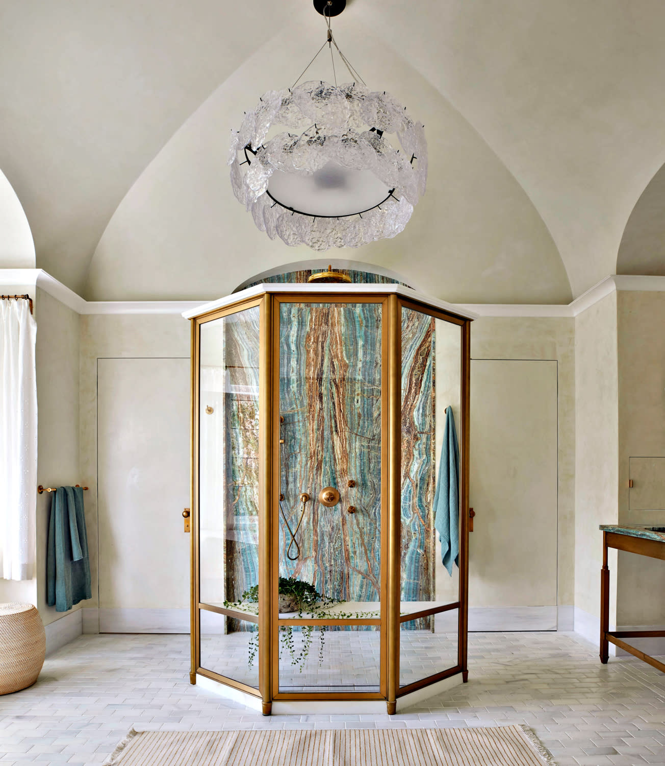 opulent bathroom with blue marble shower in the center