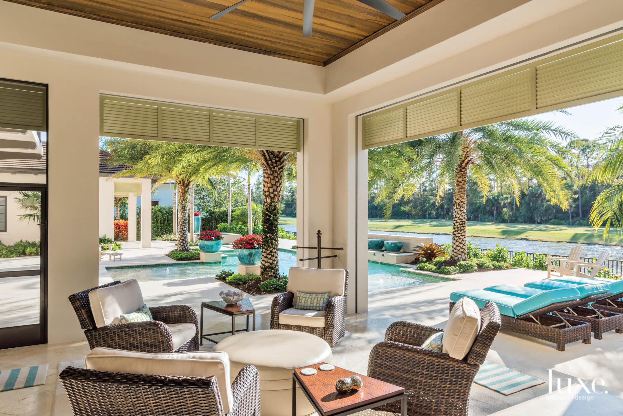 Outdoor living room overlooking pool.