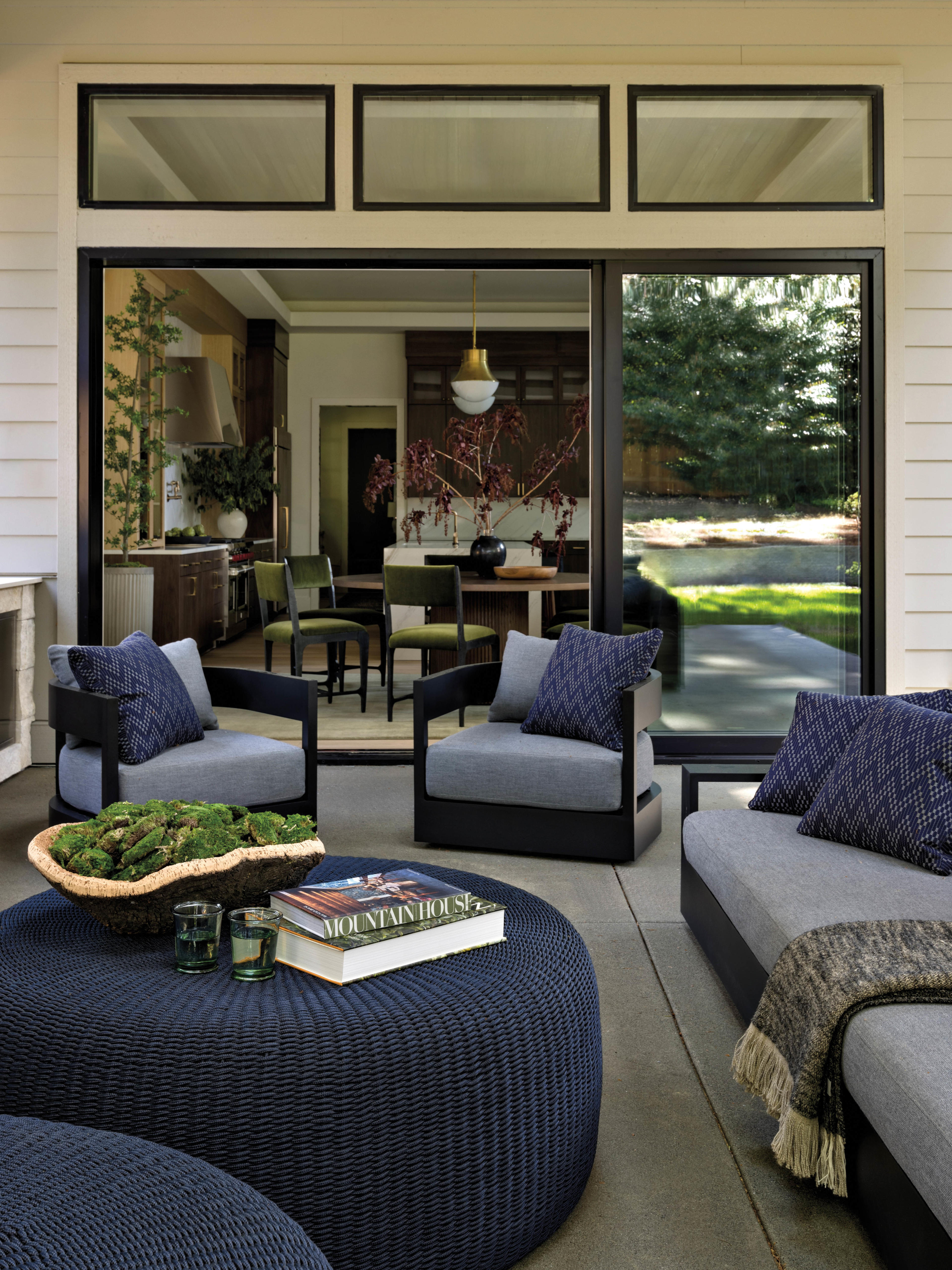 cozy patio seating area with blue chairs, sofas, and ottomans