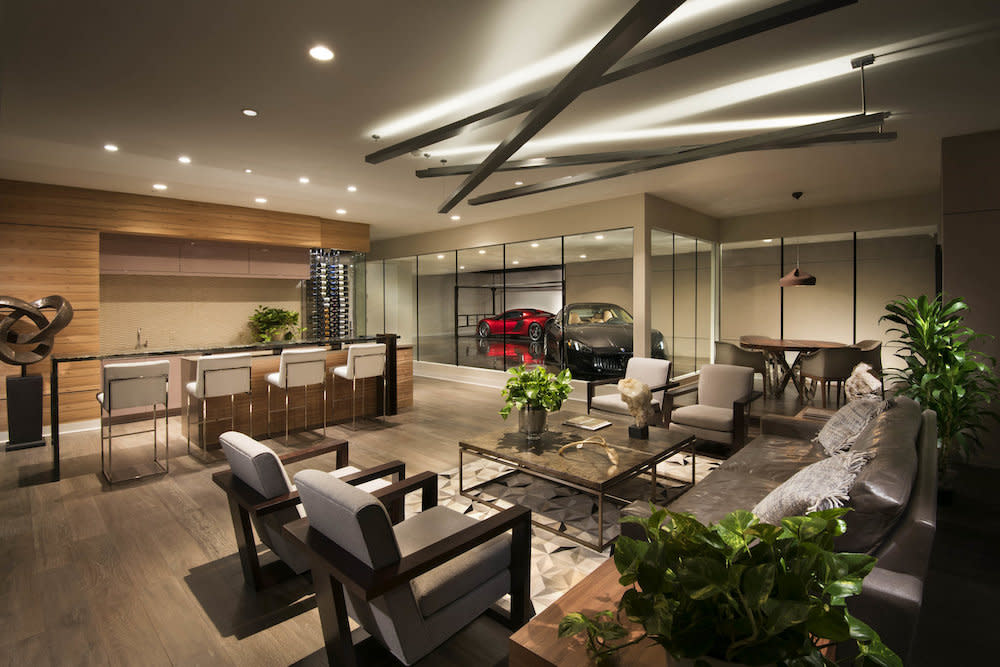 Multipurpose space with comfortable seating, bar, game table and display of high-end cars