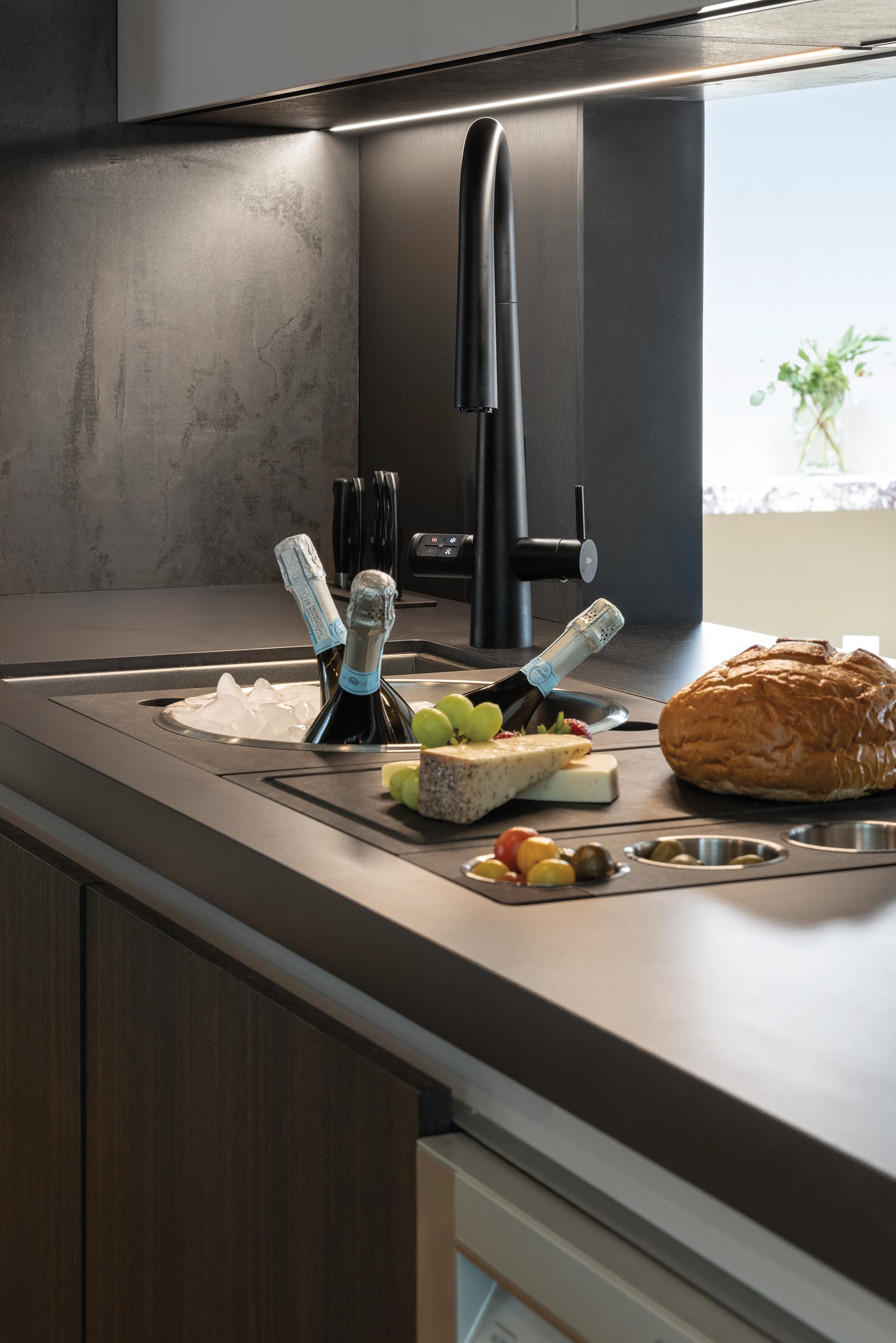 Detail of the Zip Water five-function faucet in the Pazzam Project kitchen, emphasizing refined form and high-performance hydration technology for entertaining.