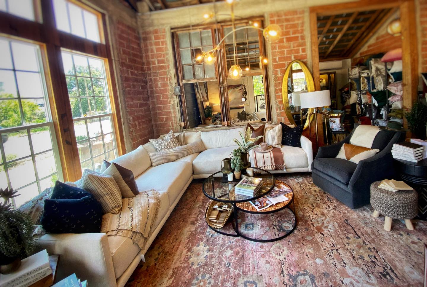 L-shaped cream sofa with red and white rug creates a warm living room.