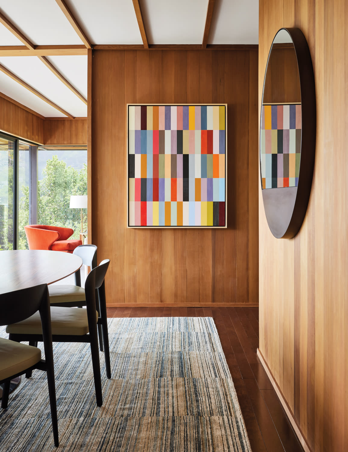 midcentury dining room with a colorful painting on one wall