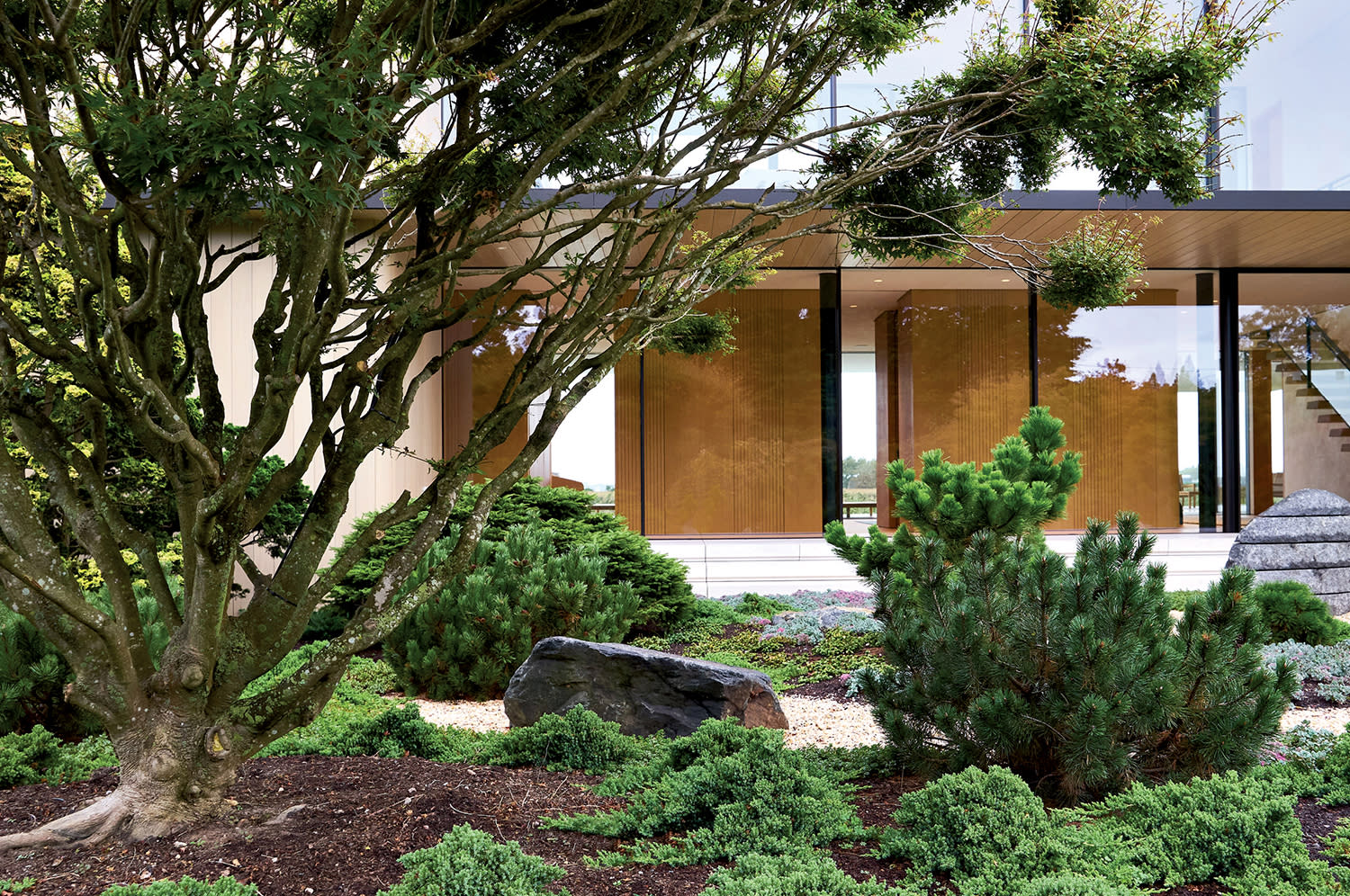 exterior view of a Hamptons home surrounded by natural landscaping
