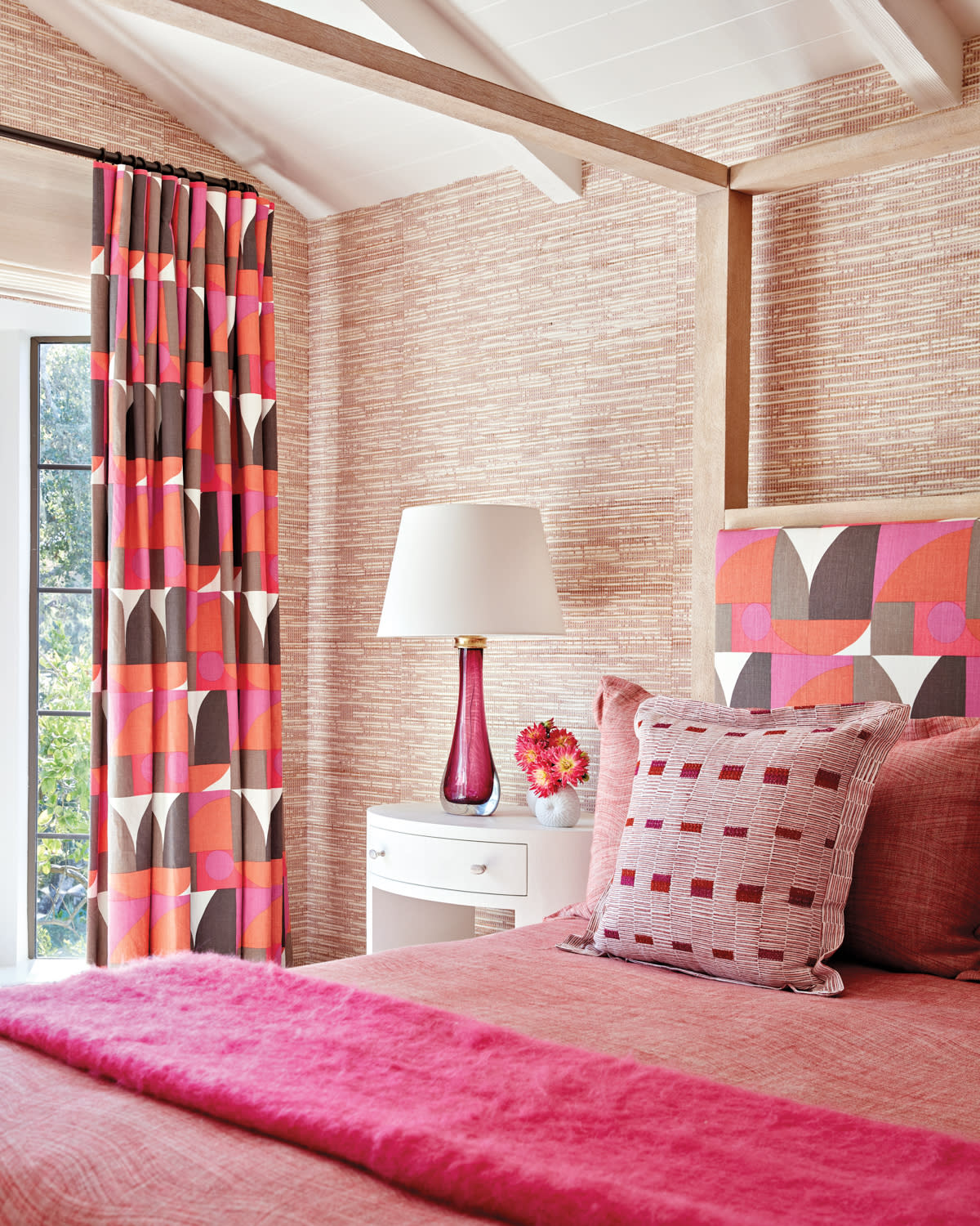 pink bedroom with a grasscloth wallcovering and canopy bed