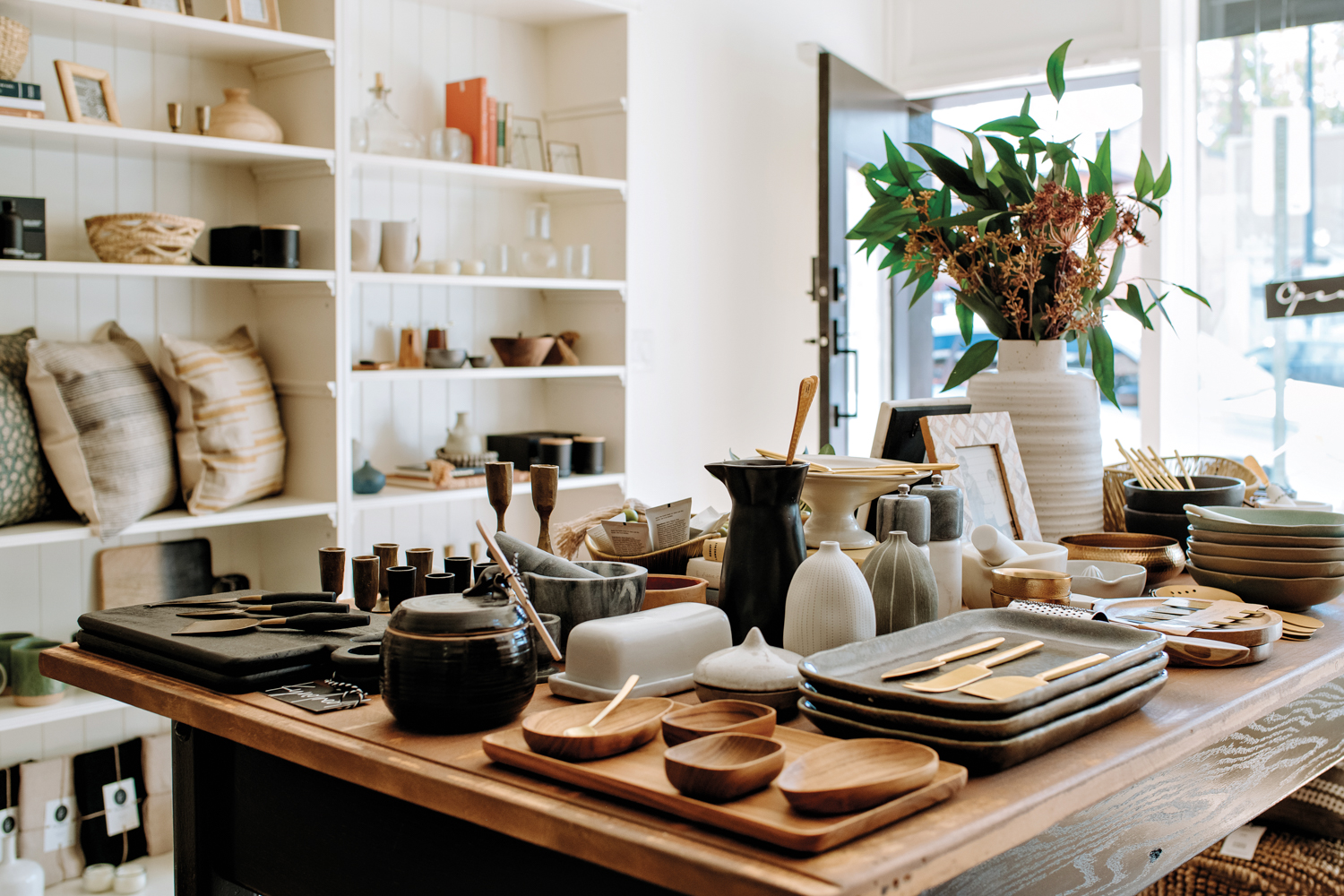 An assortment of tableware and decor arranged on a dining table at the Kyndred shop