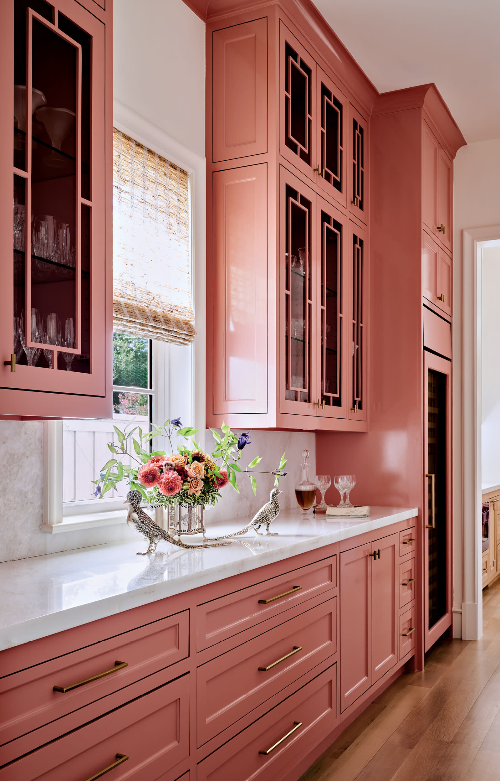 scullery kitchen with pink cabinetry and bright white marble countertops