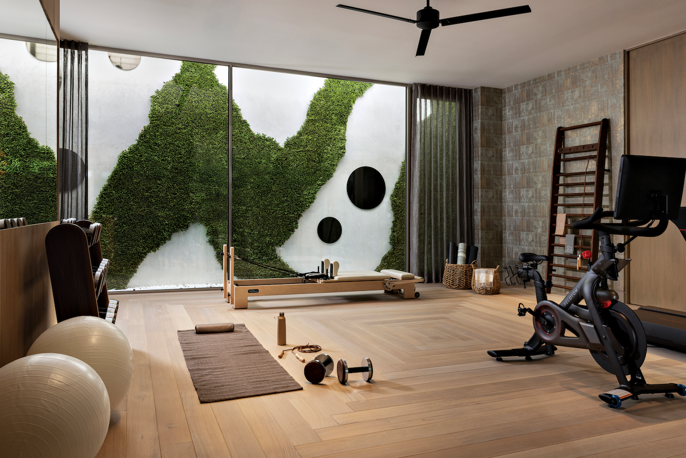 Home gym with integrated entertainment system and hidden speakers.