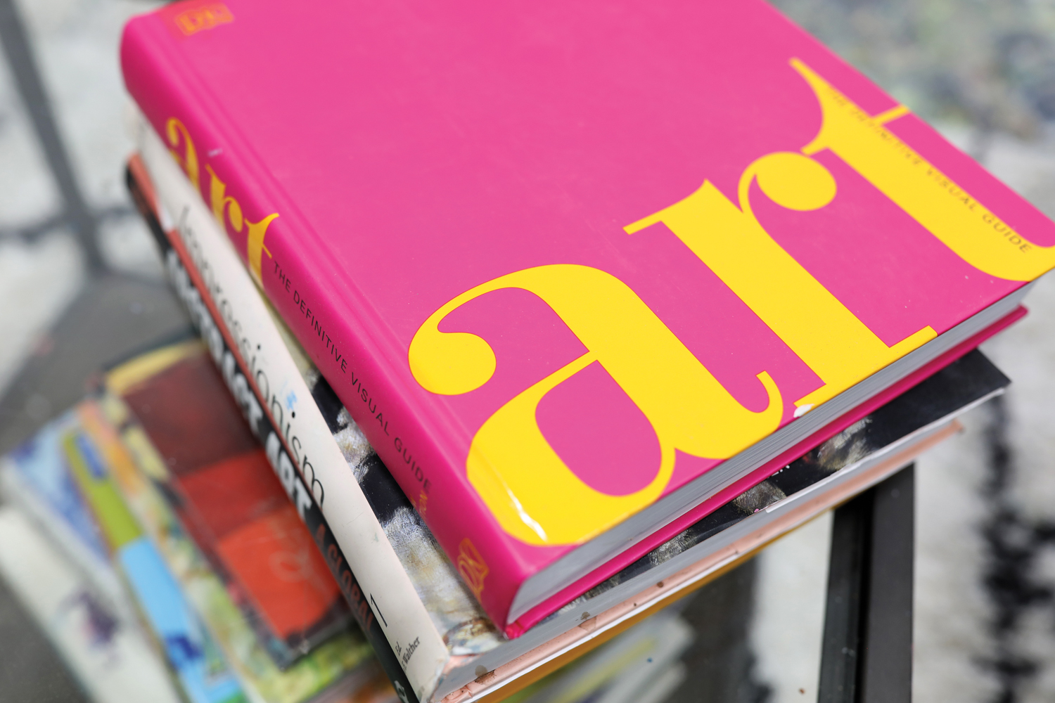 stack of hard cover art books