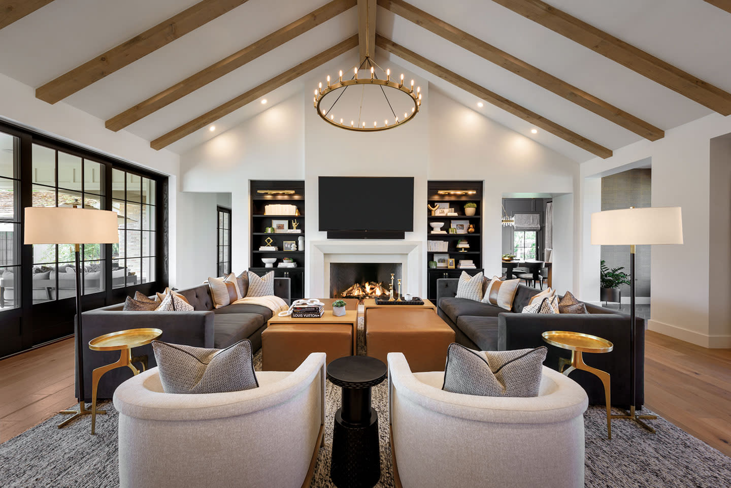 contemporary living room with exposed beams and neutral finishes