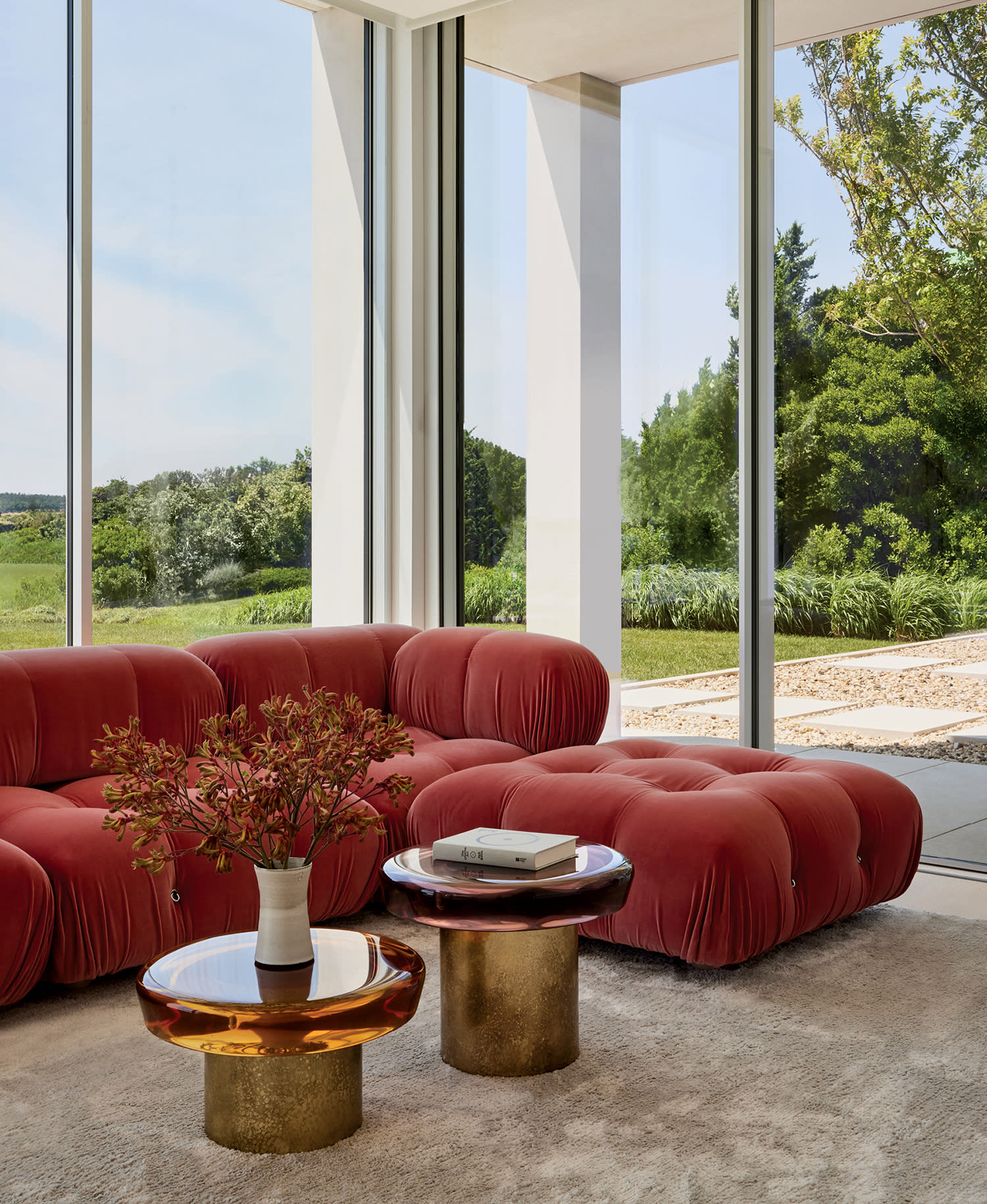 modern home office/music room with a coral B&B Italia sofa and floor-to-ceiling windows