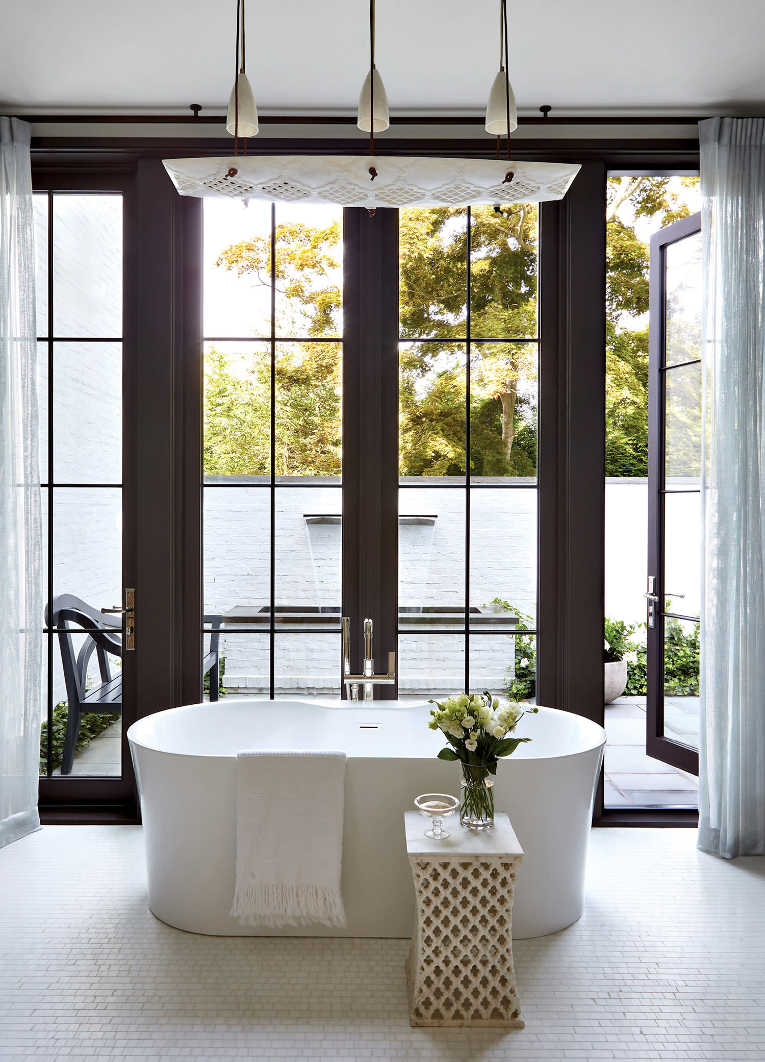 elegant bathroom with views of the courtyard outside 