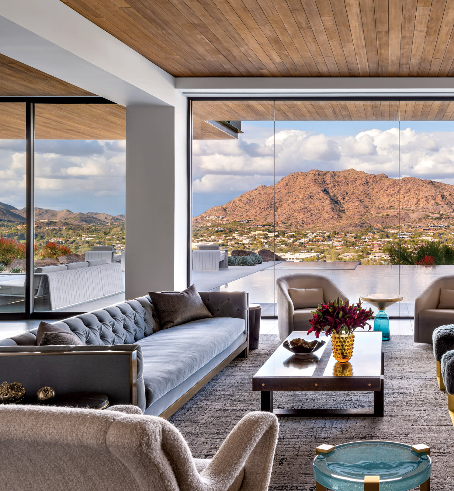 contemporary living room with a light blue sofa and a charred wood and bronze coffee table