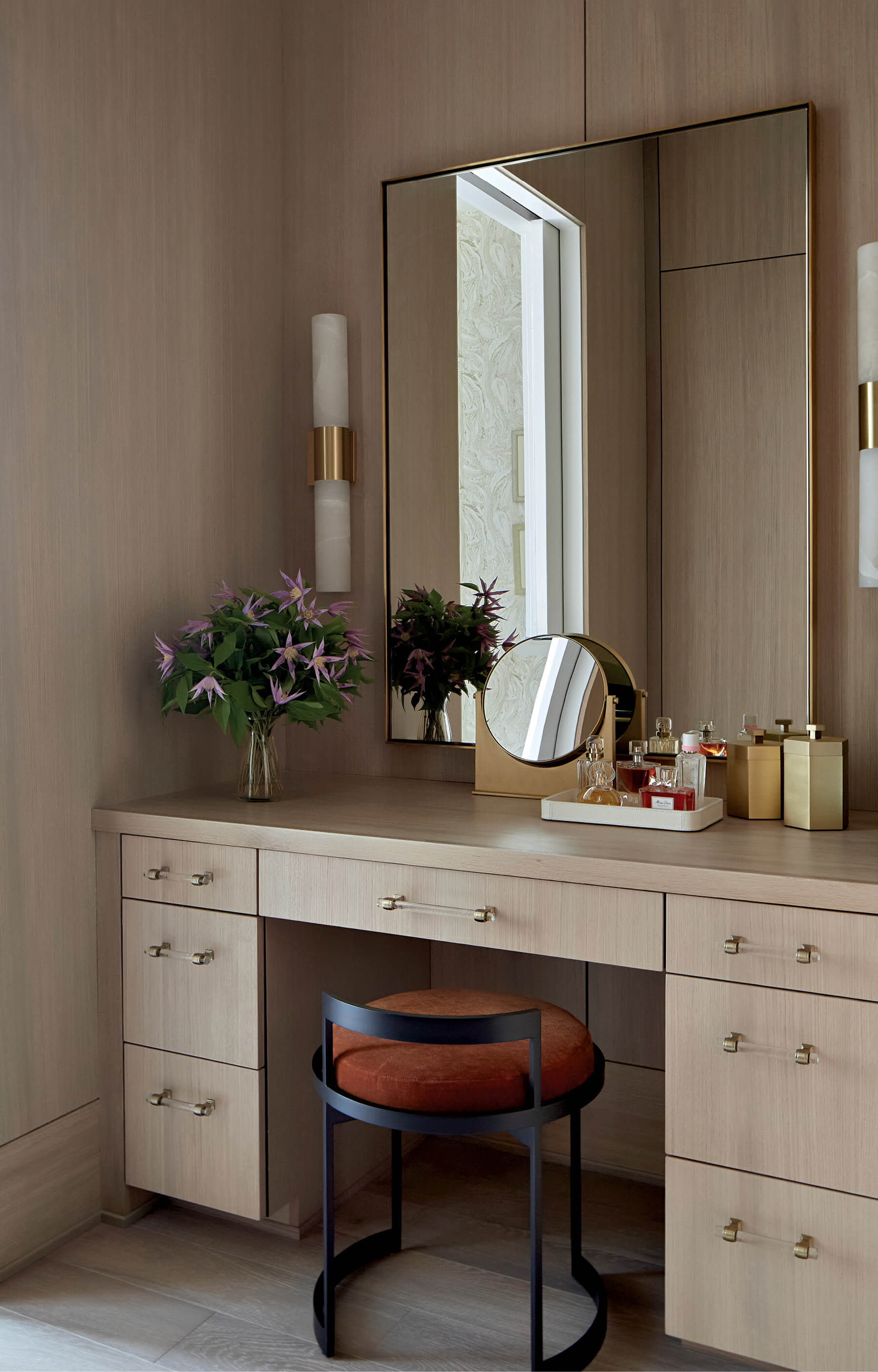 light wood vanity with a red and black chair