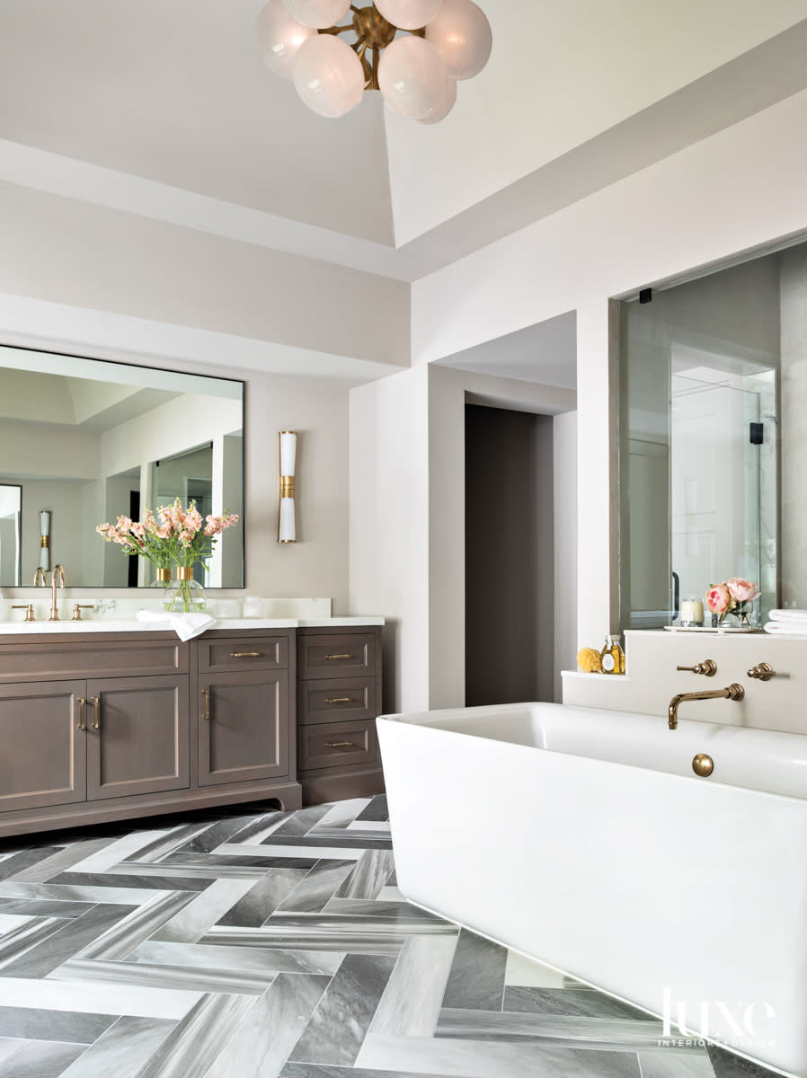 Main bathroom featuring Ann Sacks tile flooring and Circa Lighting sconces.