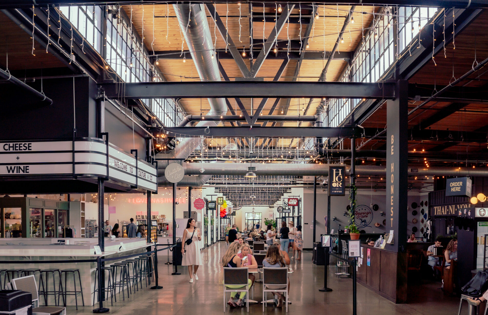 Indoor food market with exposed steel beams and vents