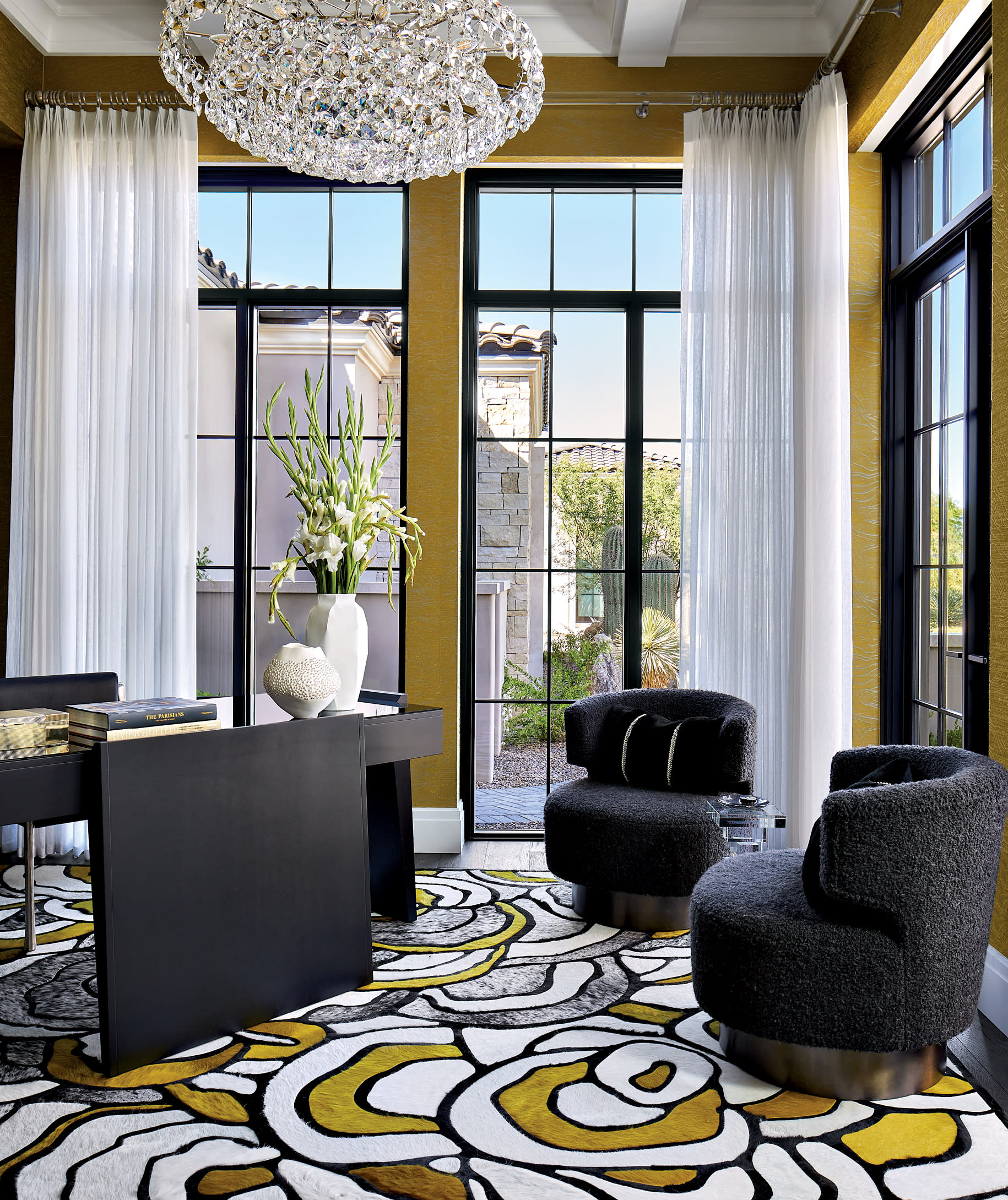 modern office with graphic lime green and white carpet, chandelier and black furniture 