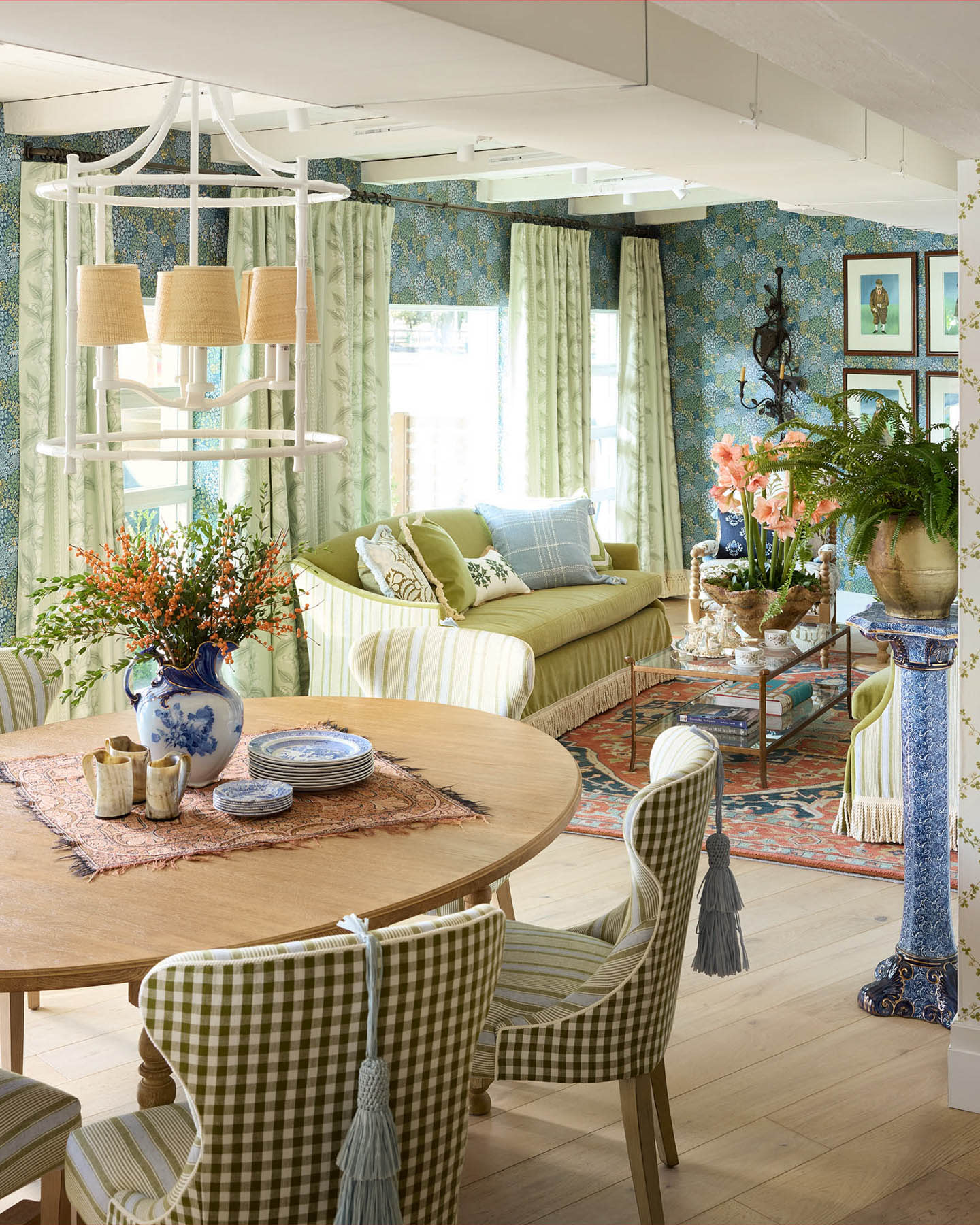 blue-green wallpaper surrounds a living and dining space