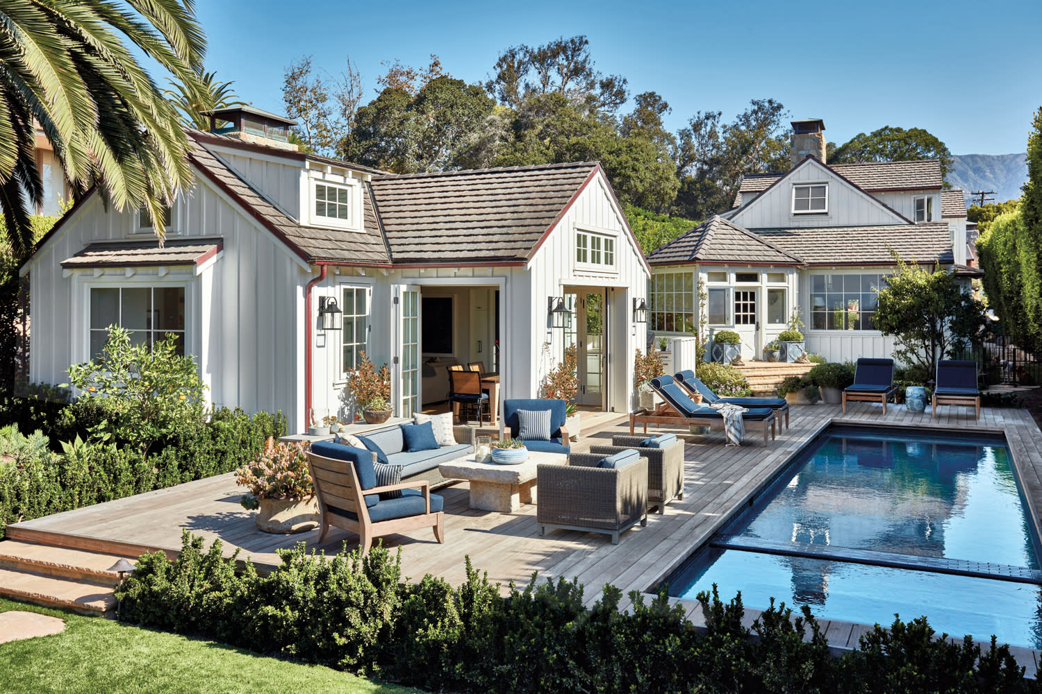 white cottage exterior with a pool