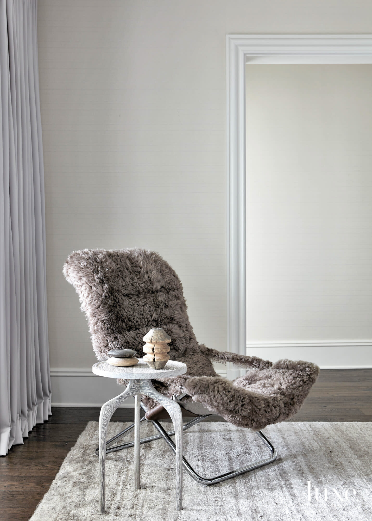 gray furry chair seating area with white accent table