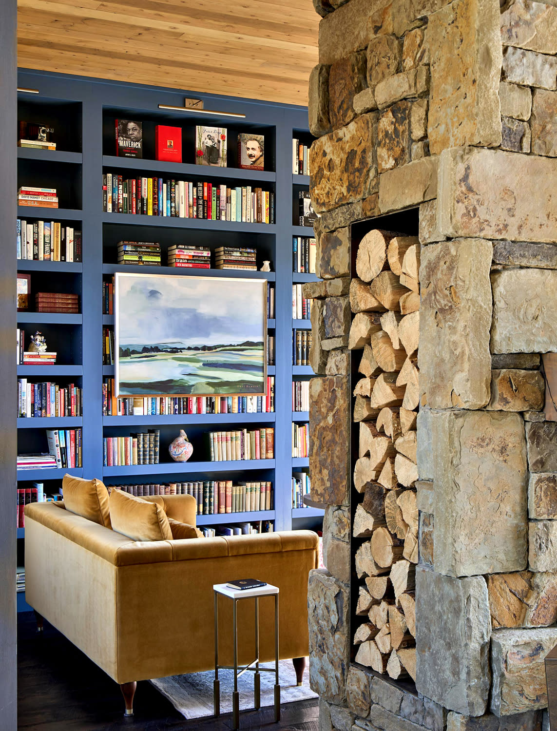 sitting room with a stone fireplace surround and contemporary furniture