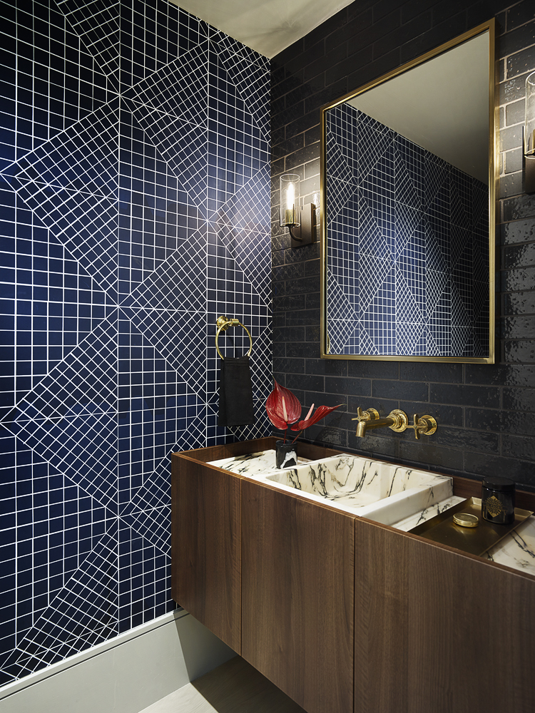 blue tile bathroom with blue wallpaper