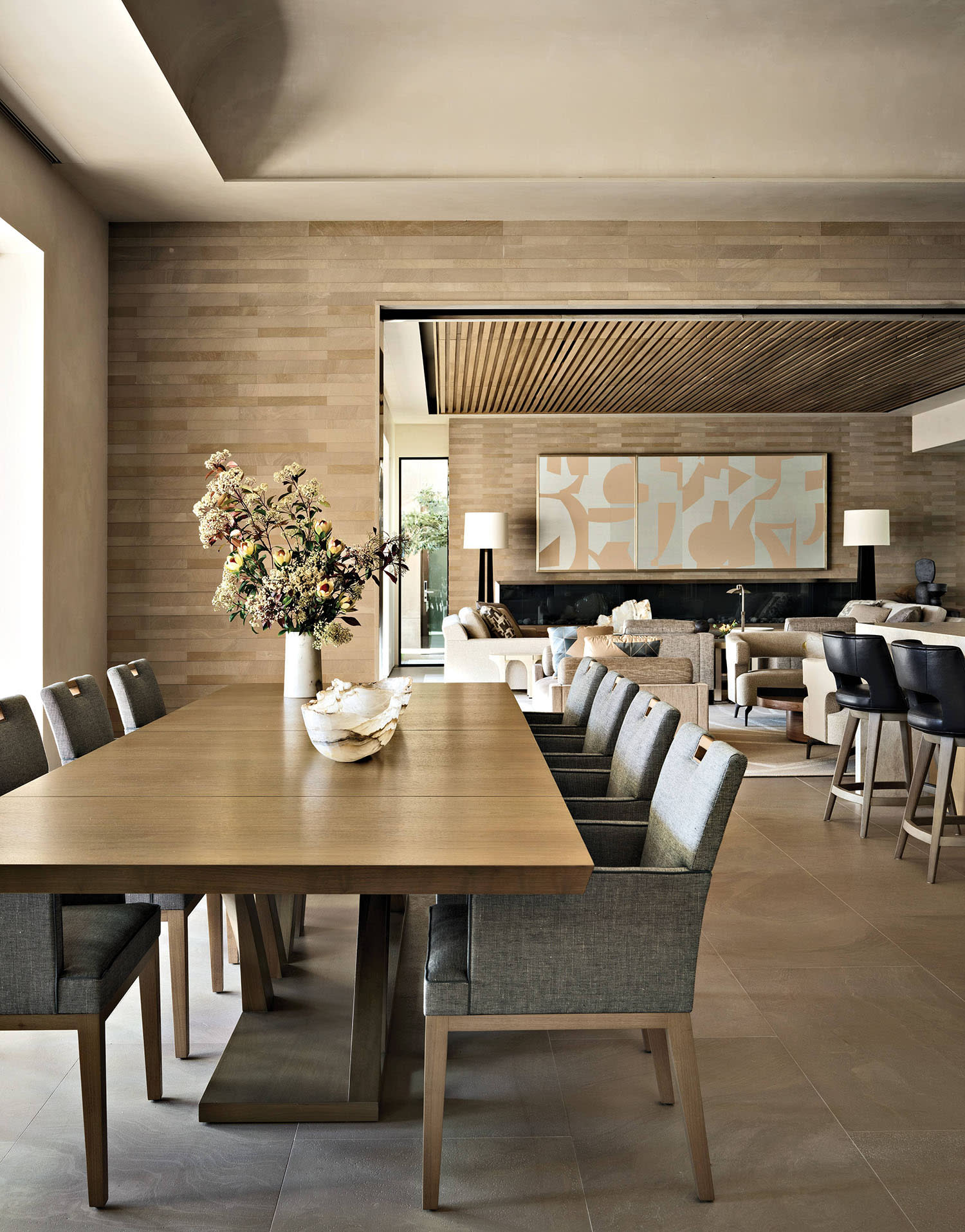 dining area with limestone tile flooring and a Hellman Chang dining table with brass inlays