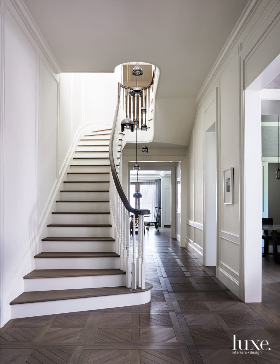 A long entry stair has a gently curved rail.