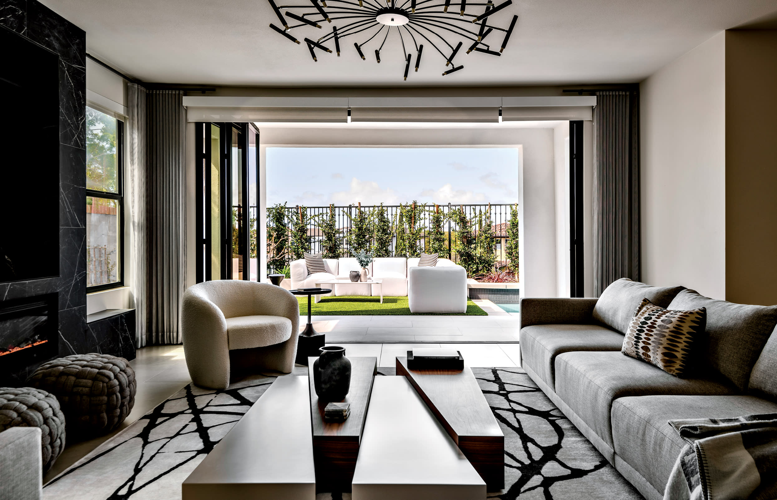 chic living room with a graphic rug and a door opening to the outdoor patio