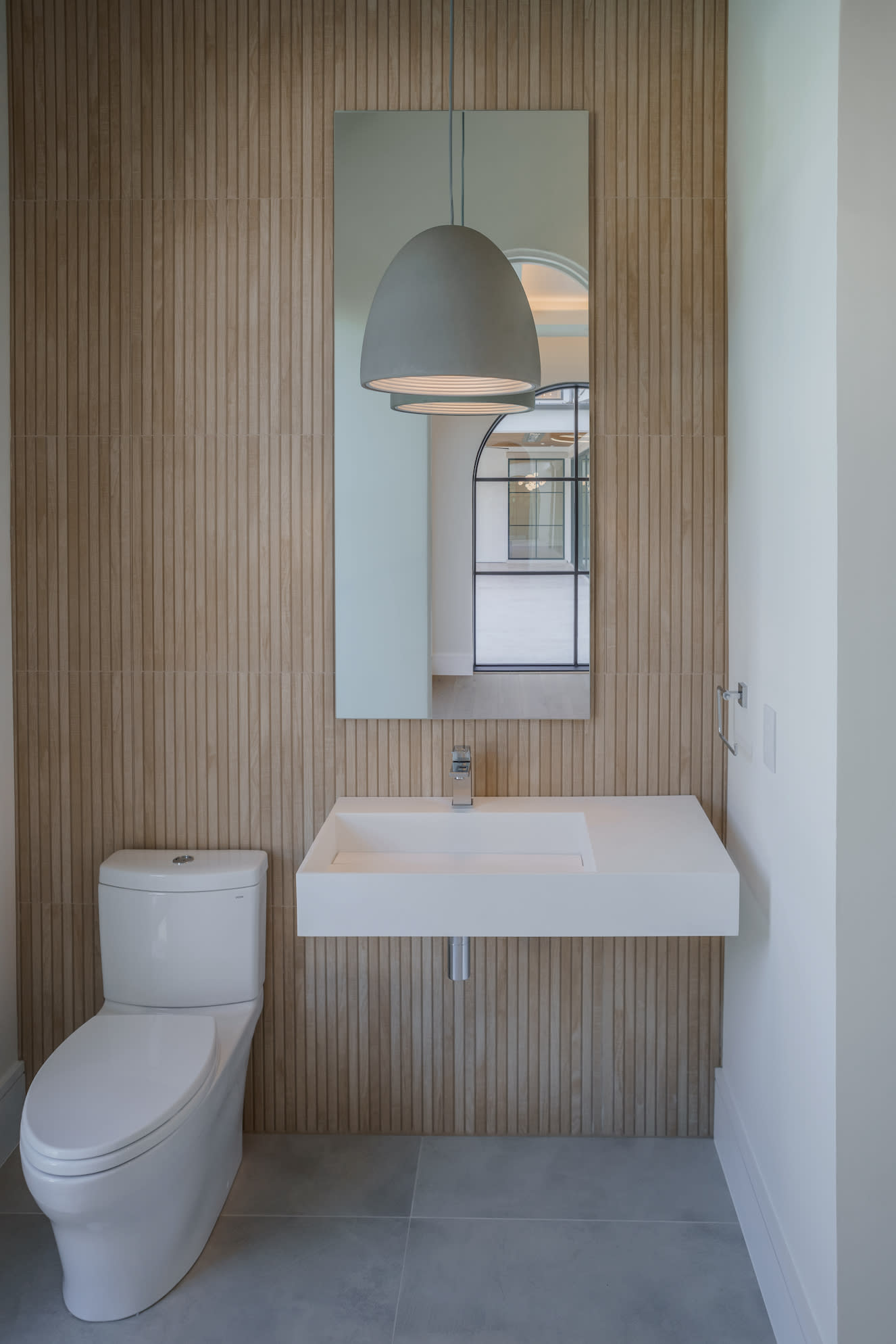 A modern bathroom with a white toilet and sink.