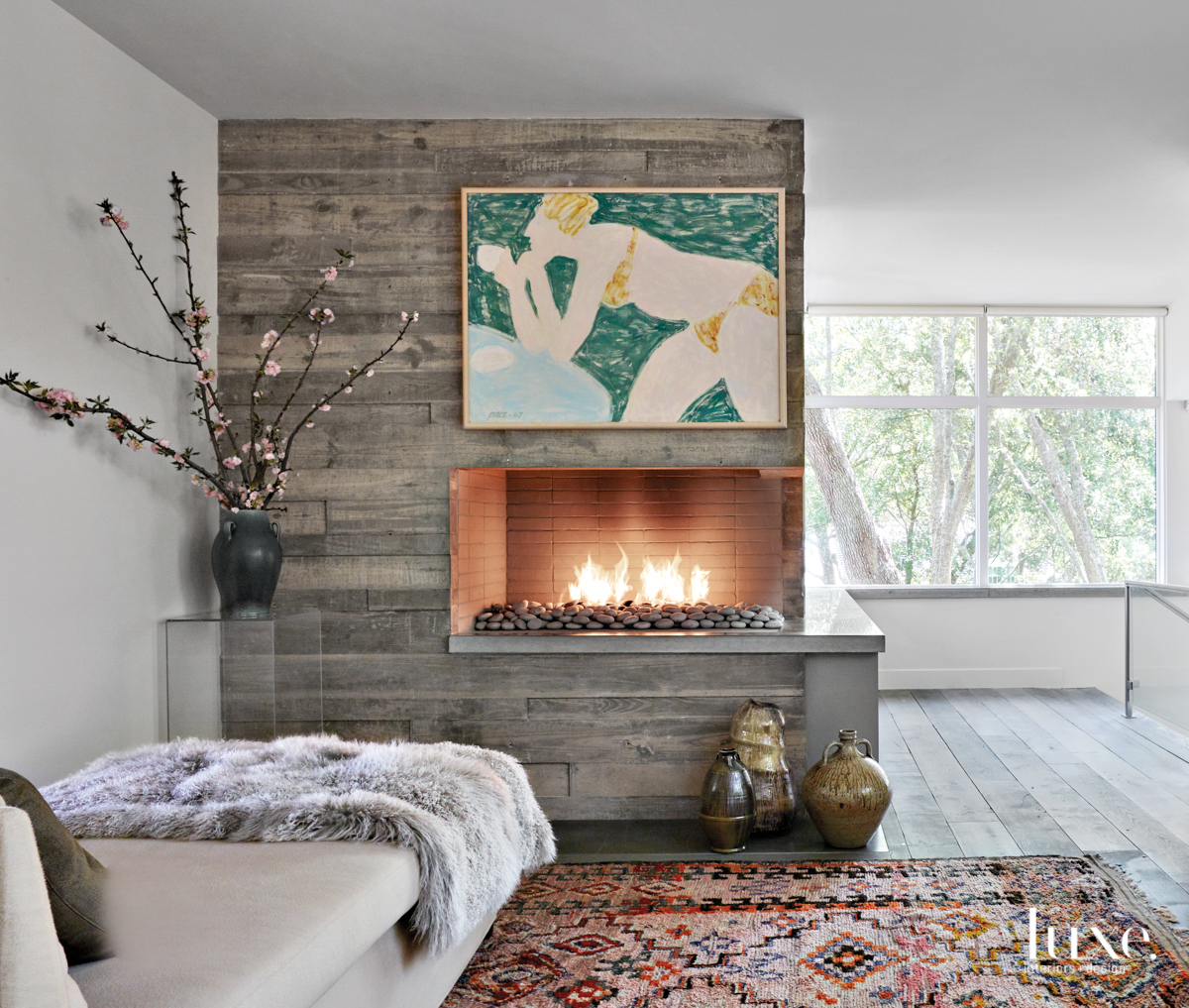 upstairs lounge with concrete fireplace and verelien chaise