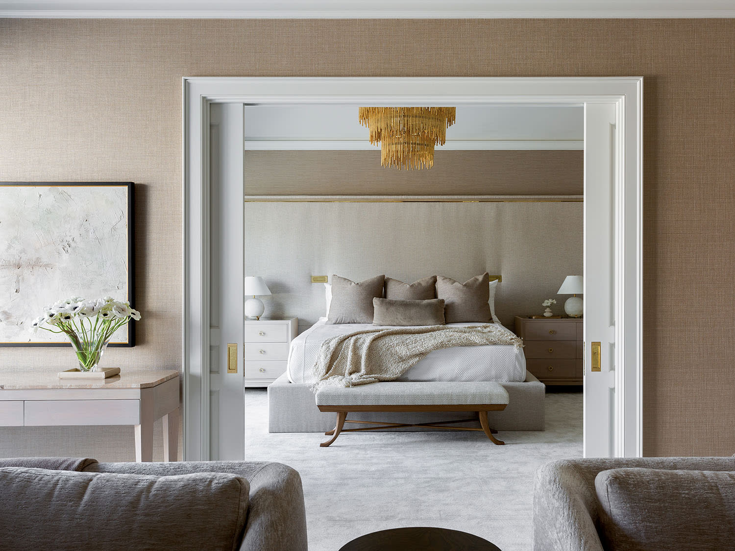 brown bedroom with a brass-and-wood-framed headboard 