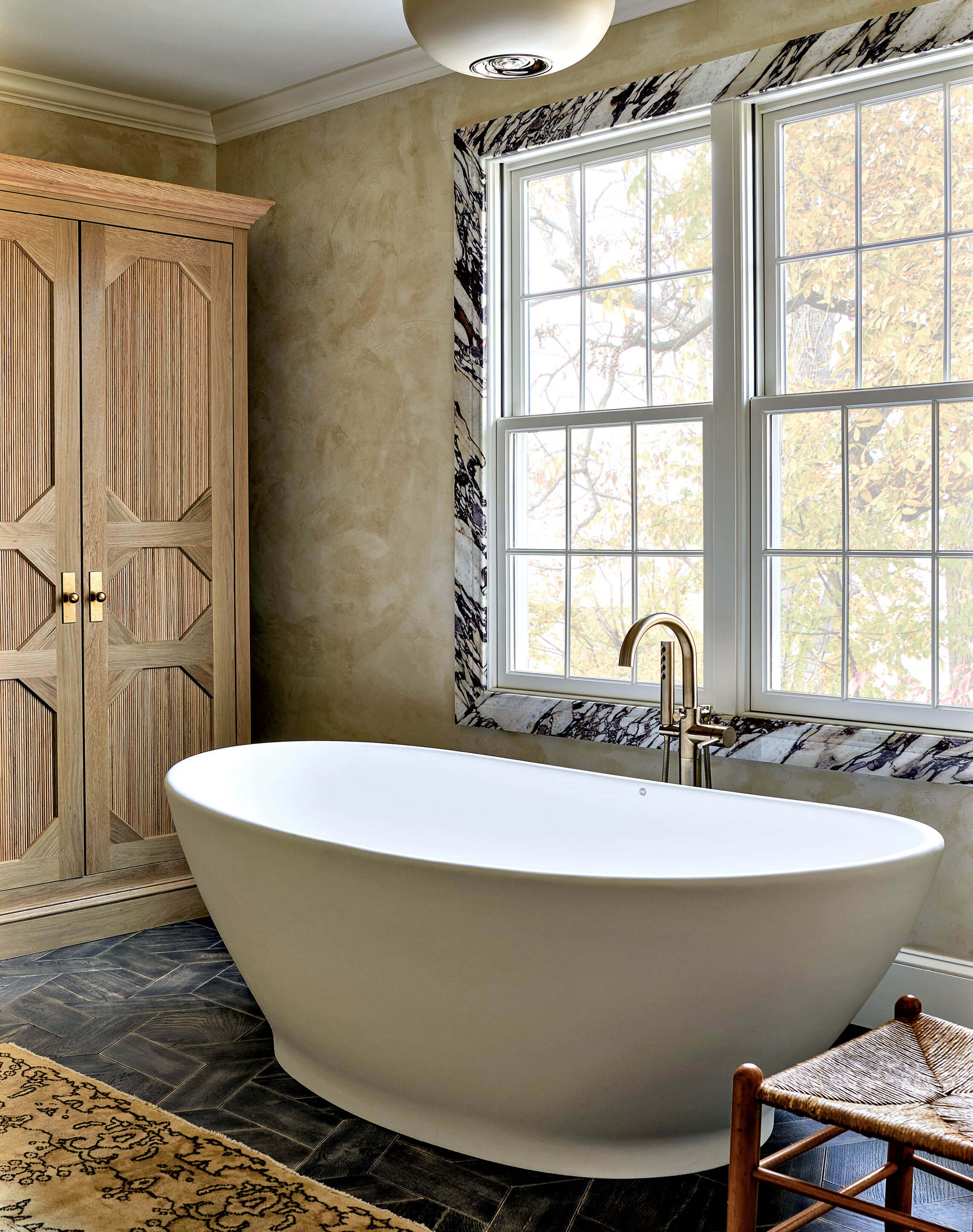 bathtub with a gold faucet in a modern bathroom