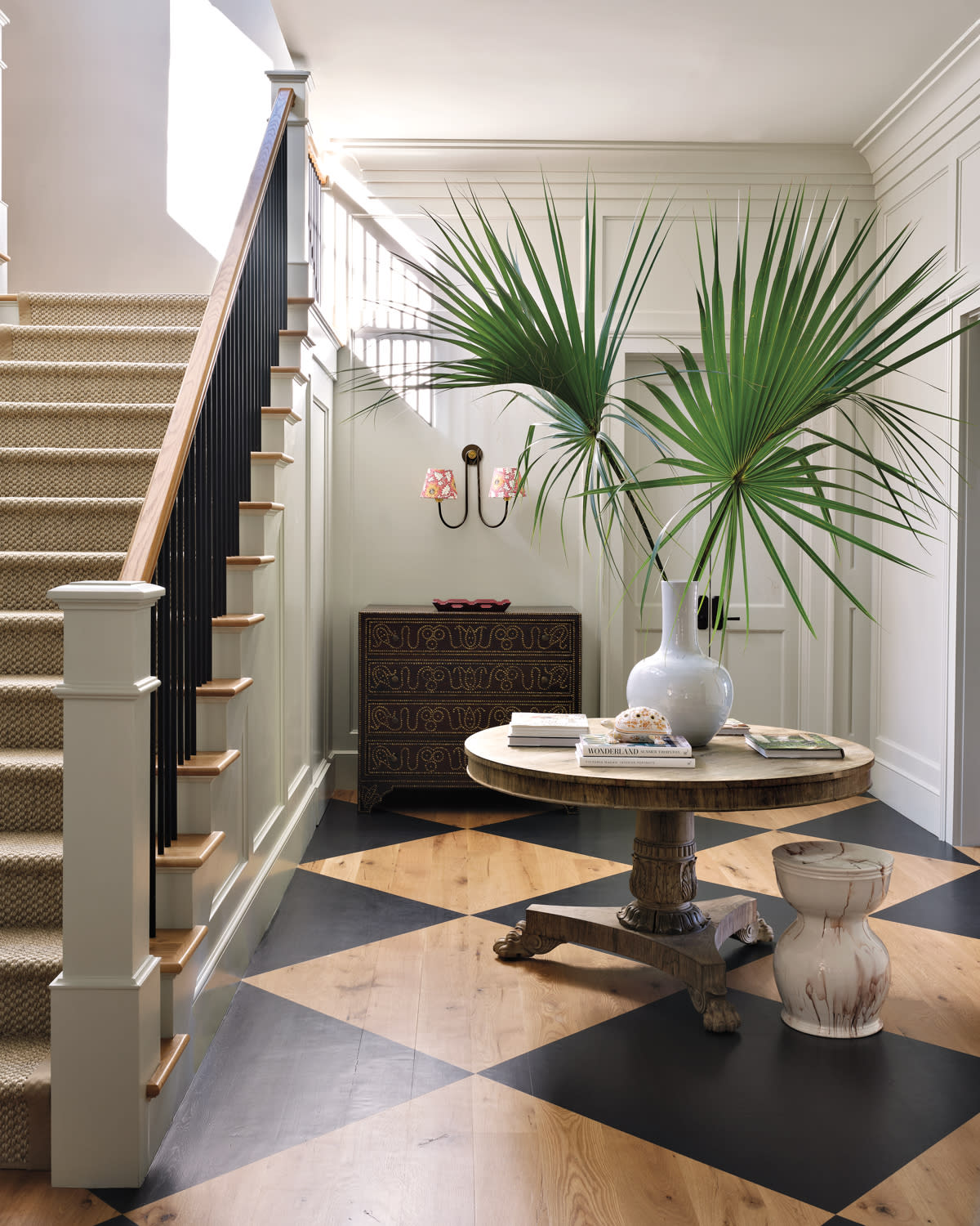 brown and black checkerboard floor in the entry of a Colonial-style home