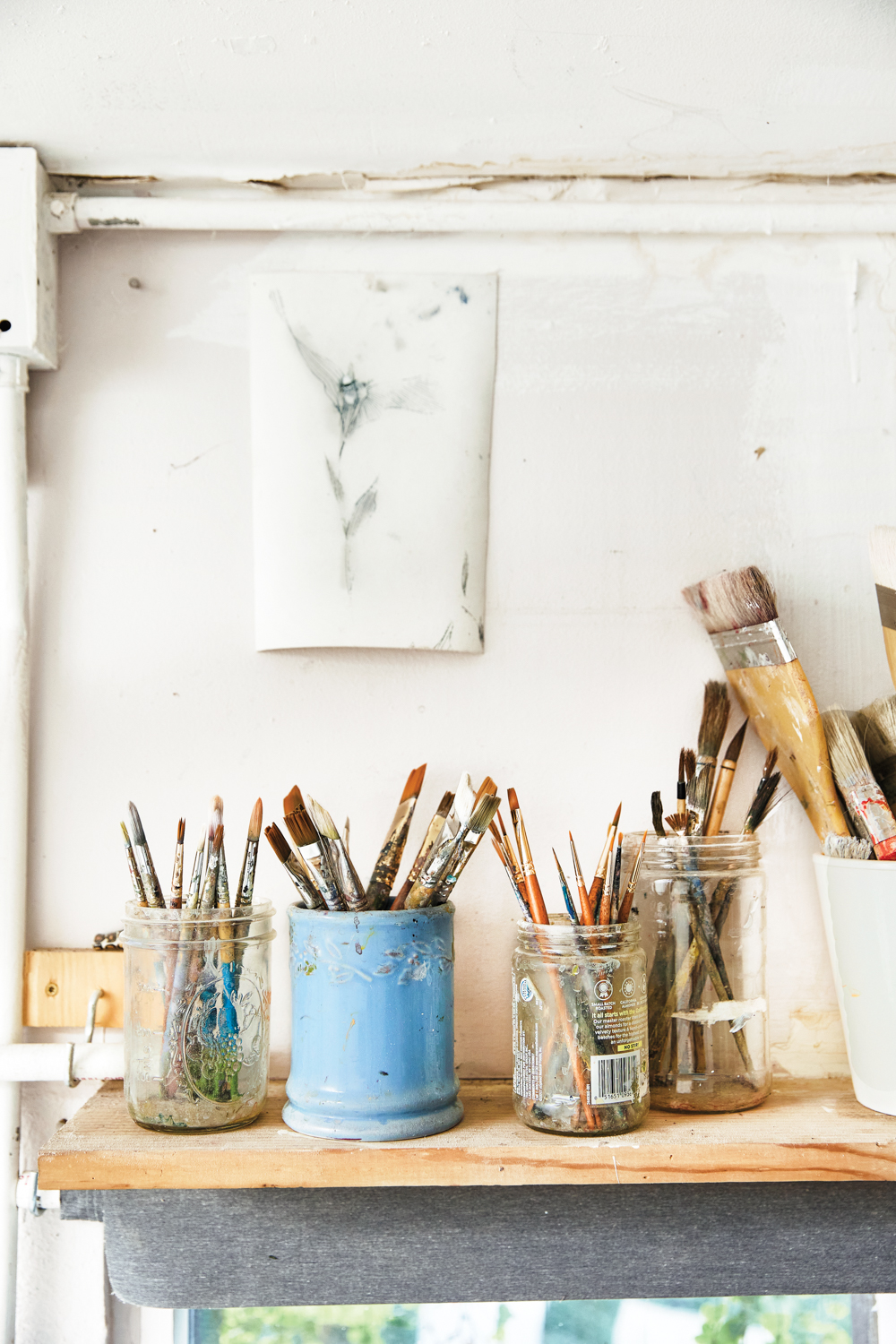 multiple paintbrushes in a variety of holders