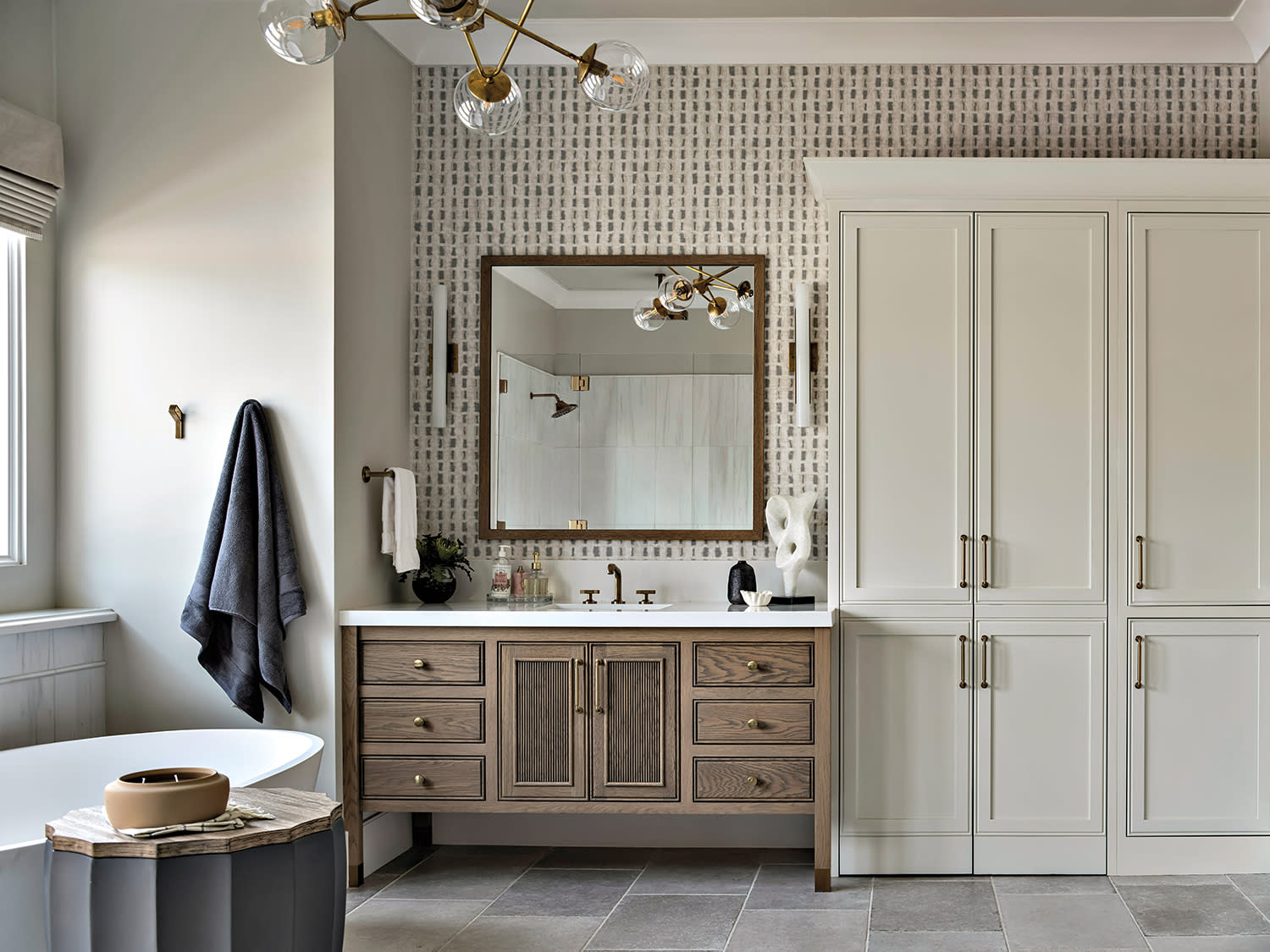 contemporary bathroom with a green and white wallpaper and a dark-stained vanity