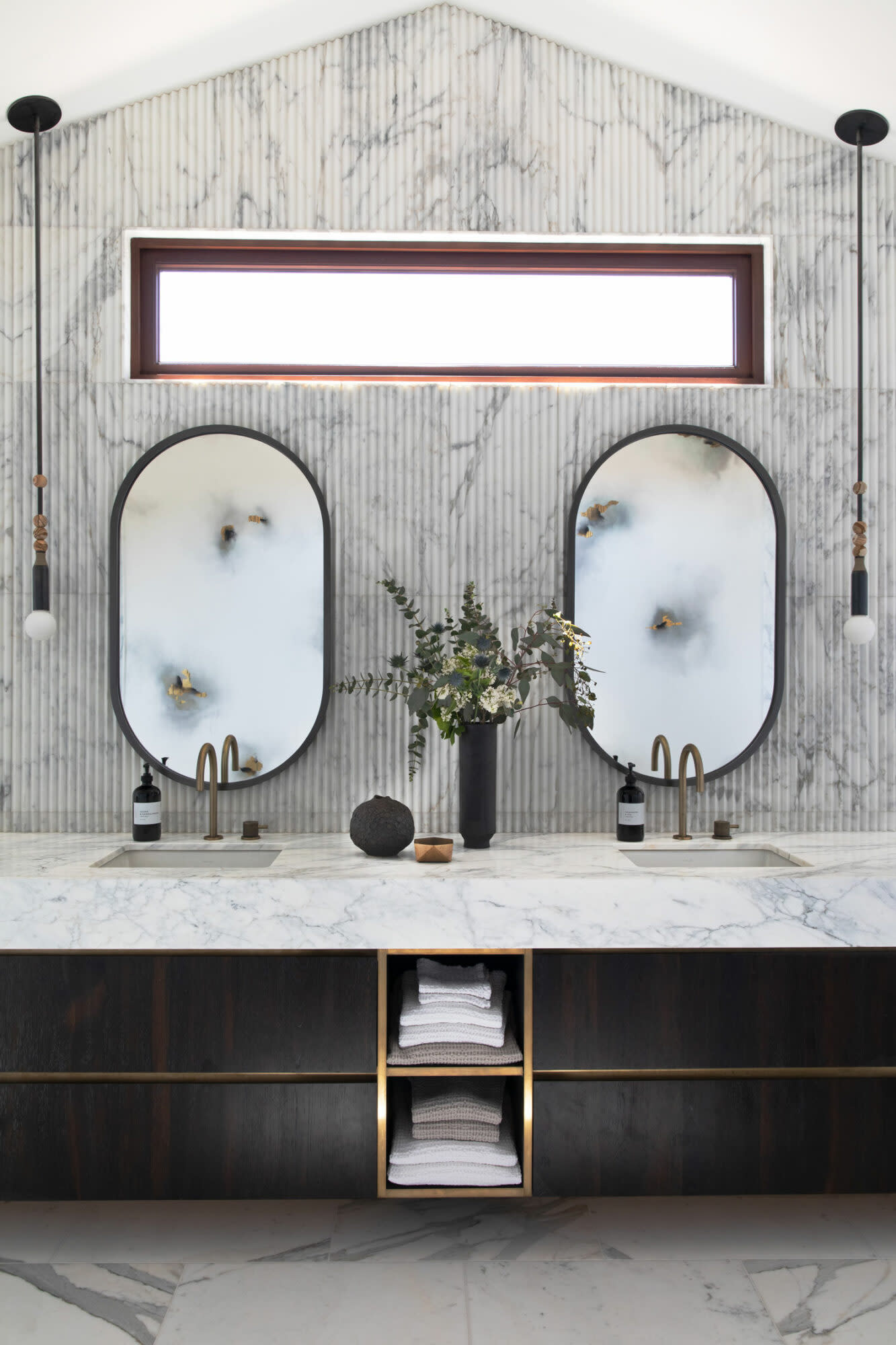 bathroom vanity with fluted cabinetry