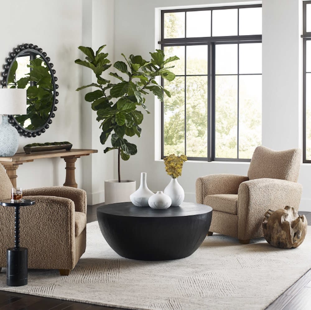 A cozy sitting area with two chairs and a coffee table.