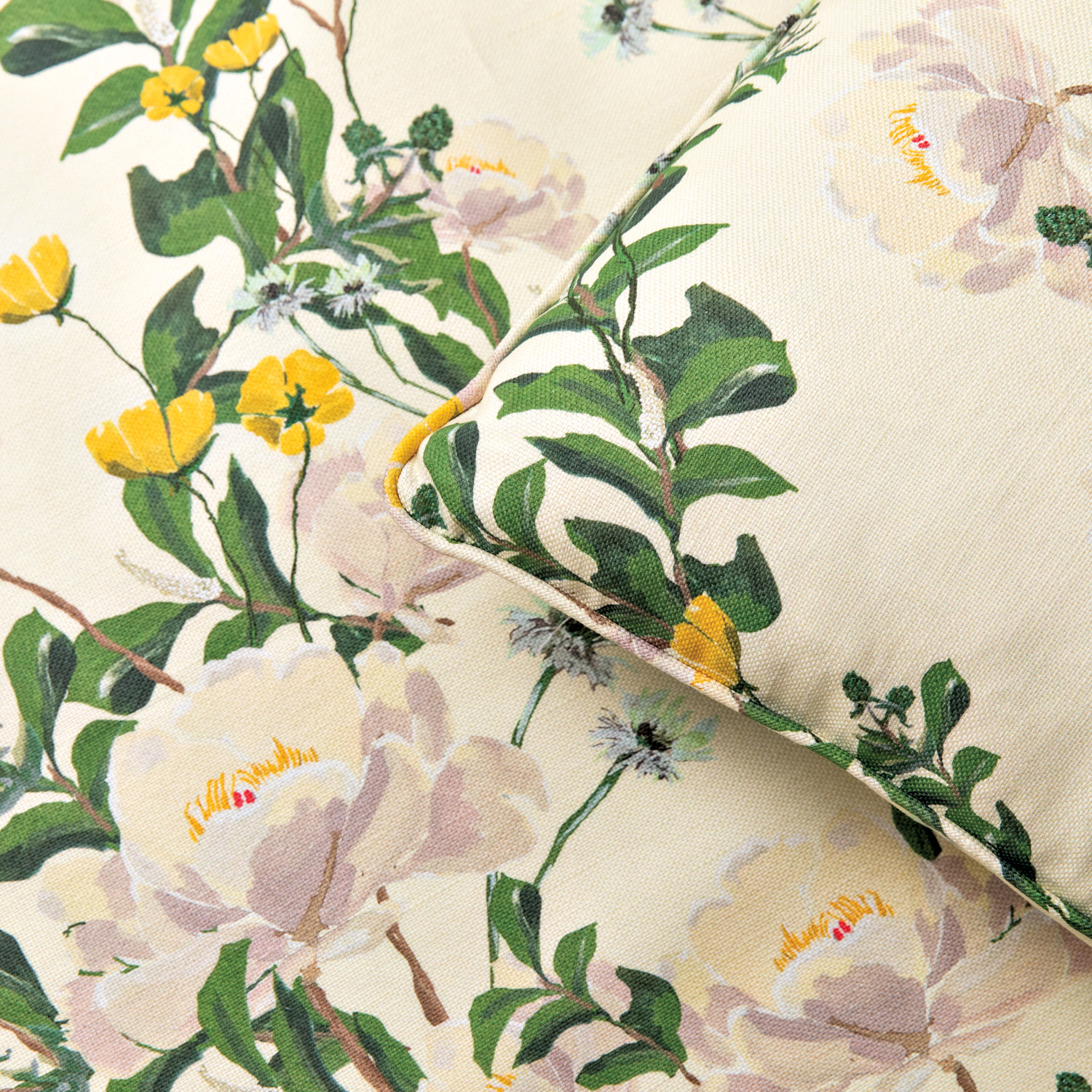 Pillow with floral-print fabric with a cream base set against a backdrop of the same fabric