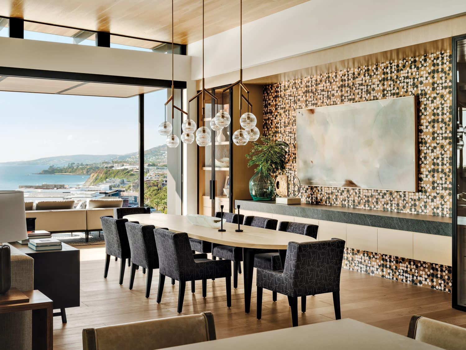 open-concept living and dining room with a graphic wallcovering on one side