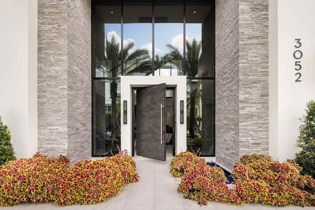 A modern home's entrance with a spacious door, welcoming visitors into a contemporary living space.