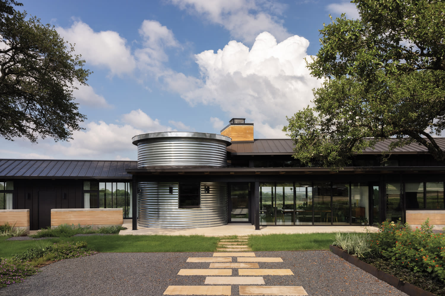 exterior of a metal-clad silo-inspired bar attached to a Texas home