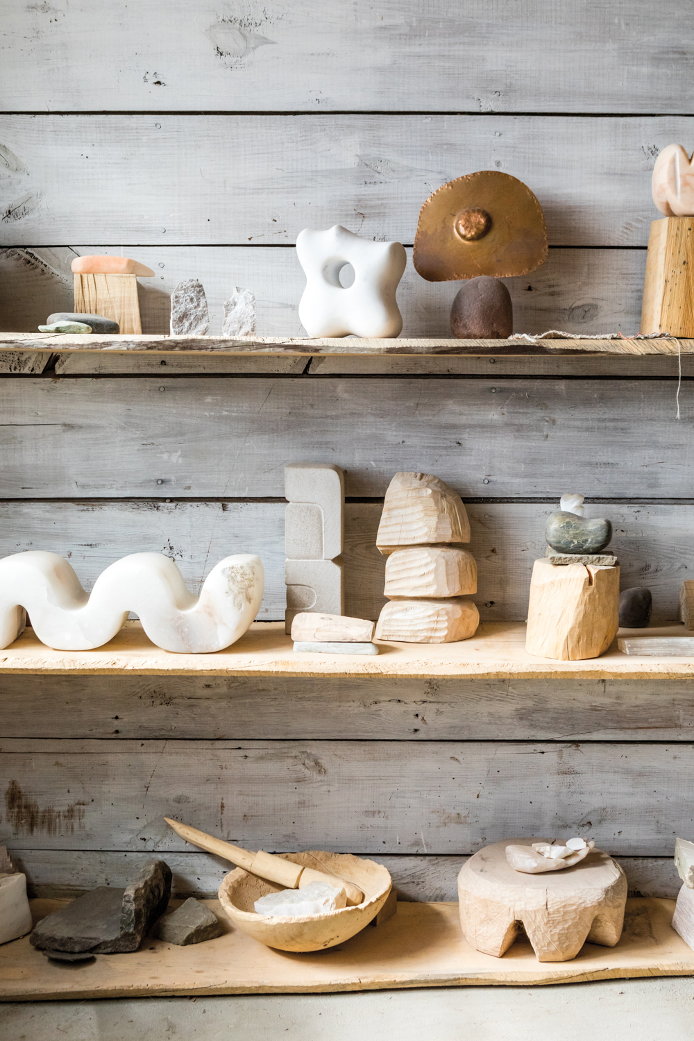 wood and stone sculptures on a shelf