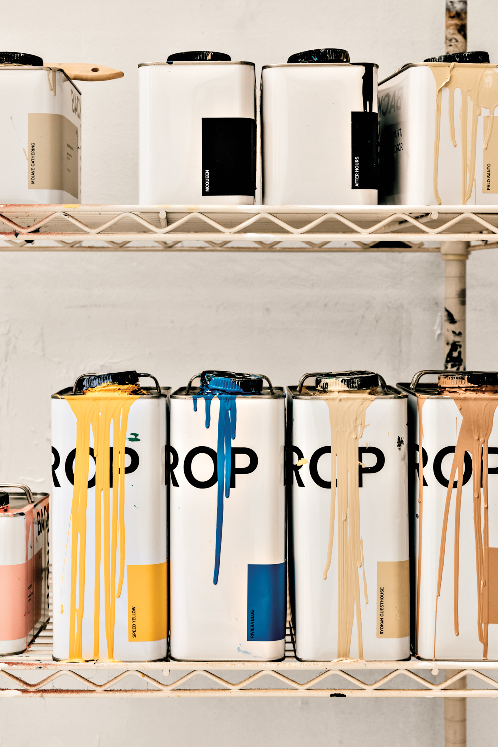 paint splattered canisters sitting in a row