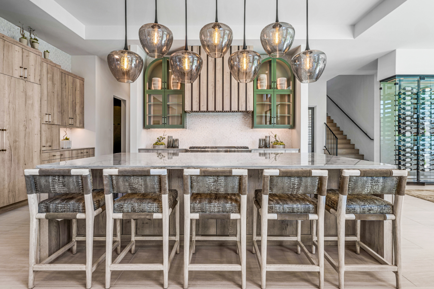 Modern Mediterranean, Fort Worth: Bright kitchen showcasing a stylish center island and a chic wine rack, inviting warmth and functionality to the heart of the home. 